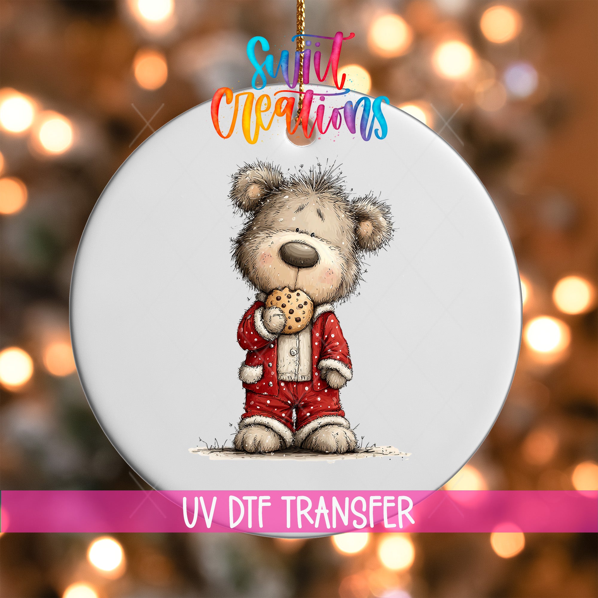 A white ornament with a cartoon image of a bear wearing a red outfit and holding a cookie.