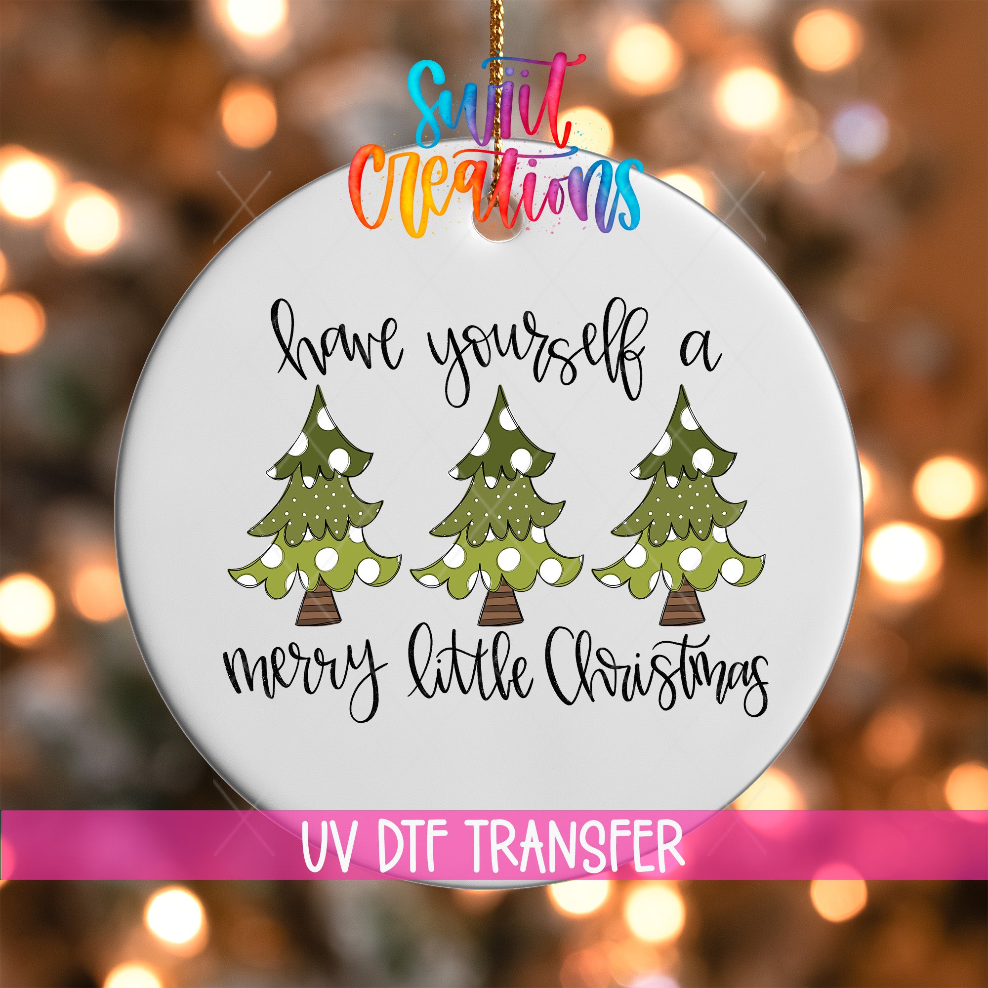 A white ornament with a message about having oneself a Merry Little Christmas, along with three Christmas trees.