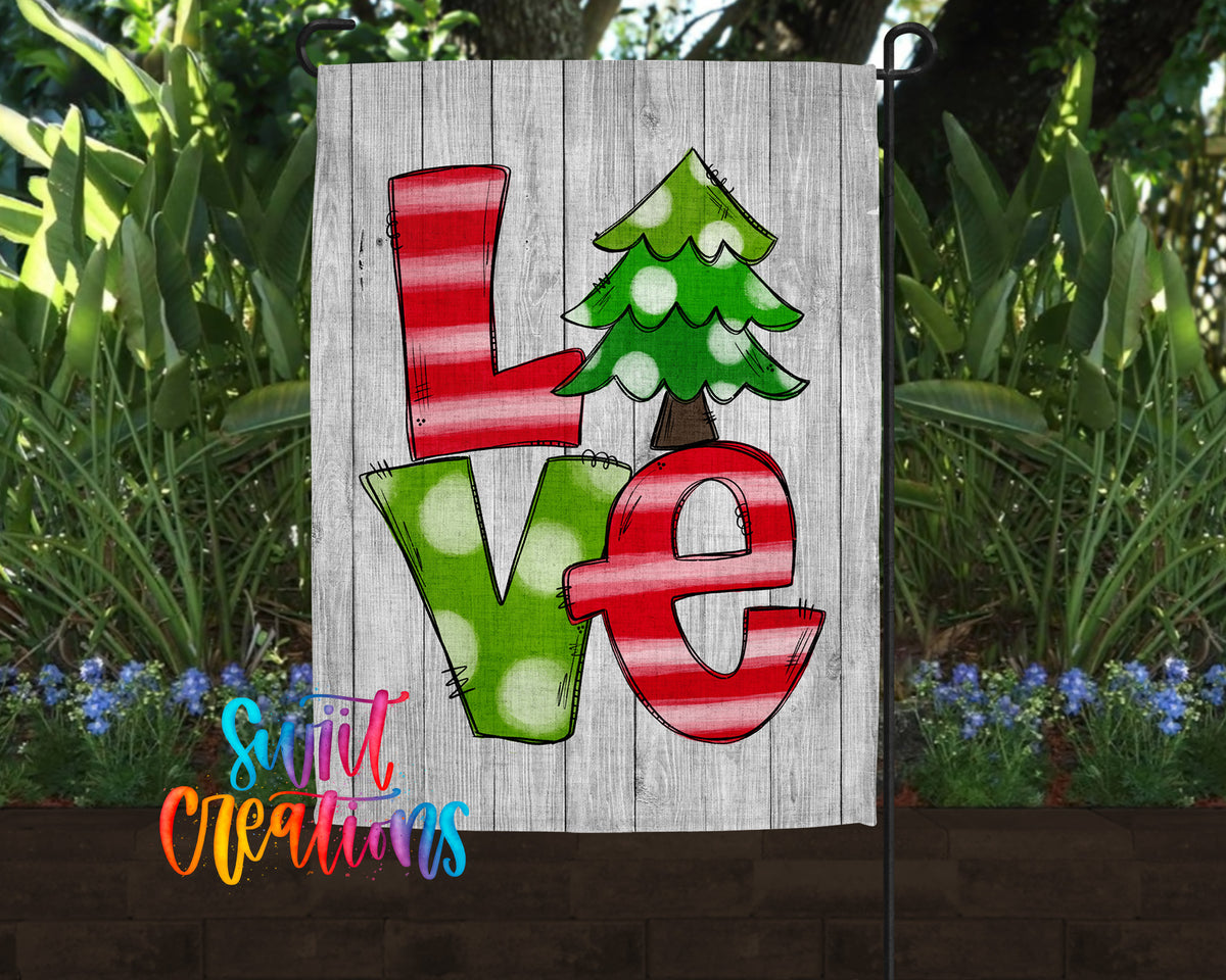 A wooden sign with the word "Love" written on it, featuring a Christmas tree design.