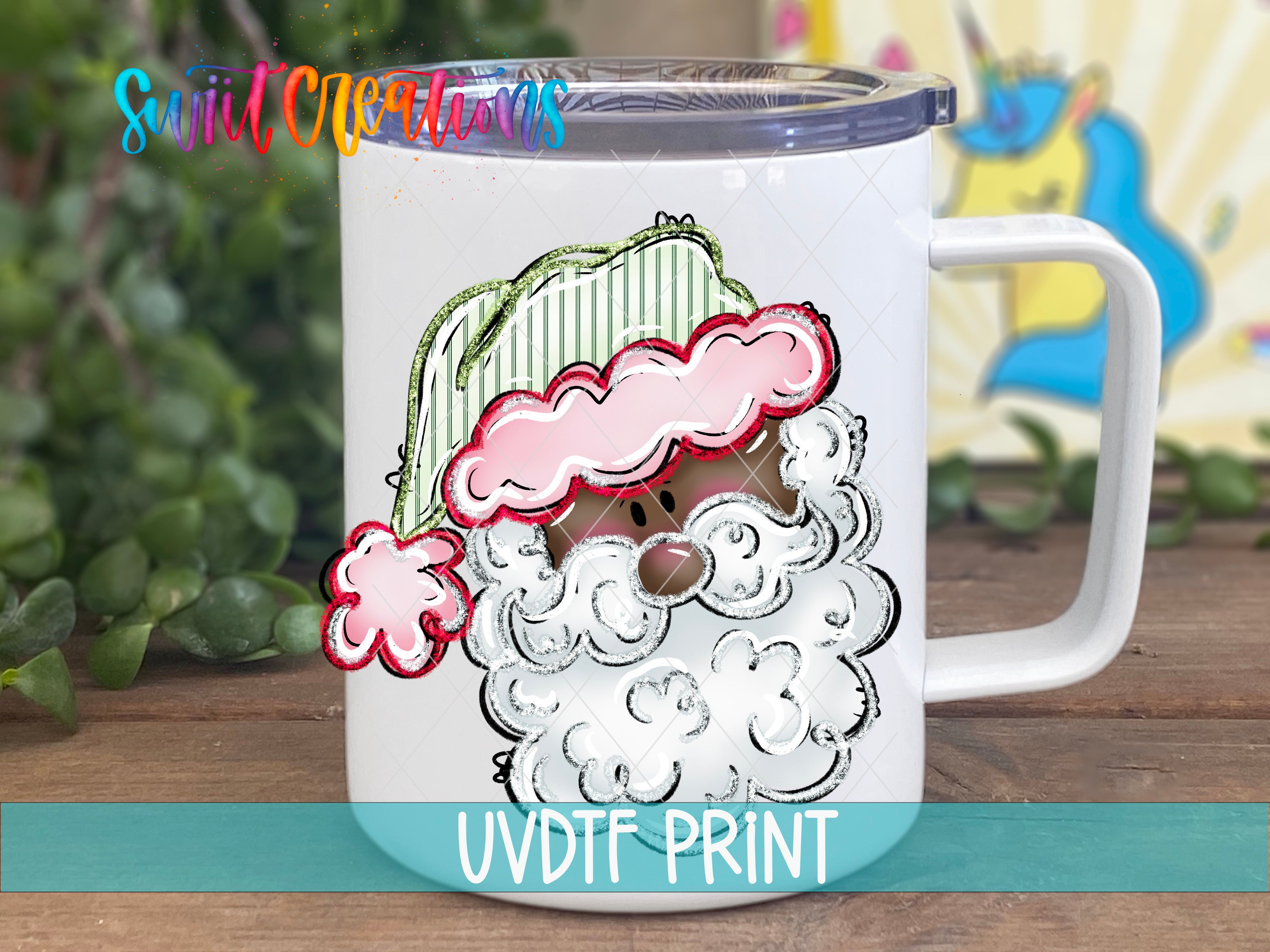 A white mug with a colorful illustration of a Santa Claus face on it, placed on a wooden surface.