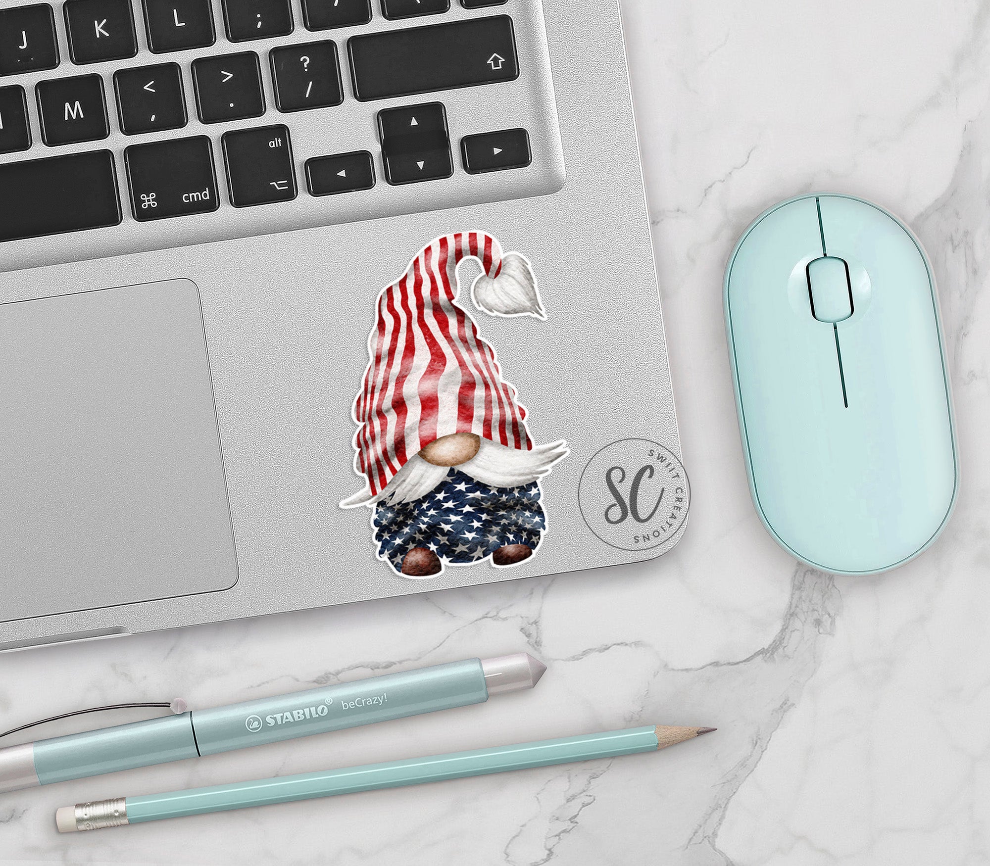 a laptop with a sticker of a gnome on it