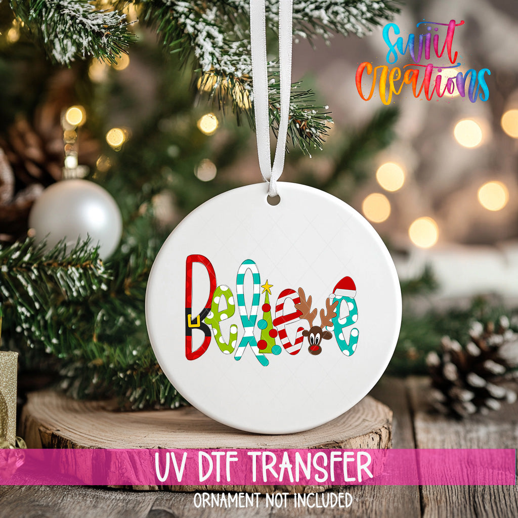 A white ceramic ornament with the word "Believe" written on it, hanging on a Christmas tree.