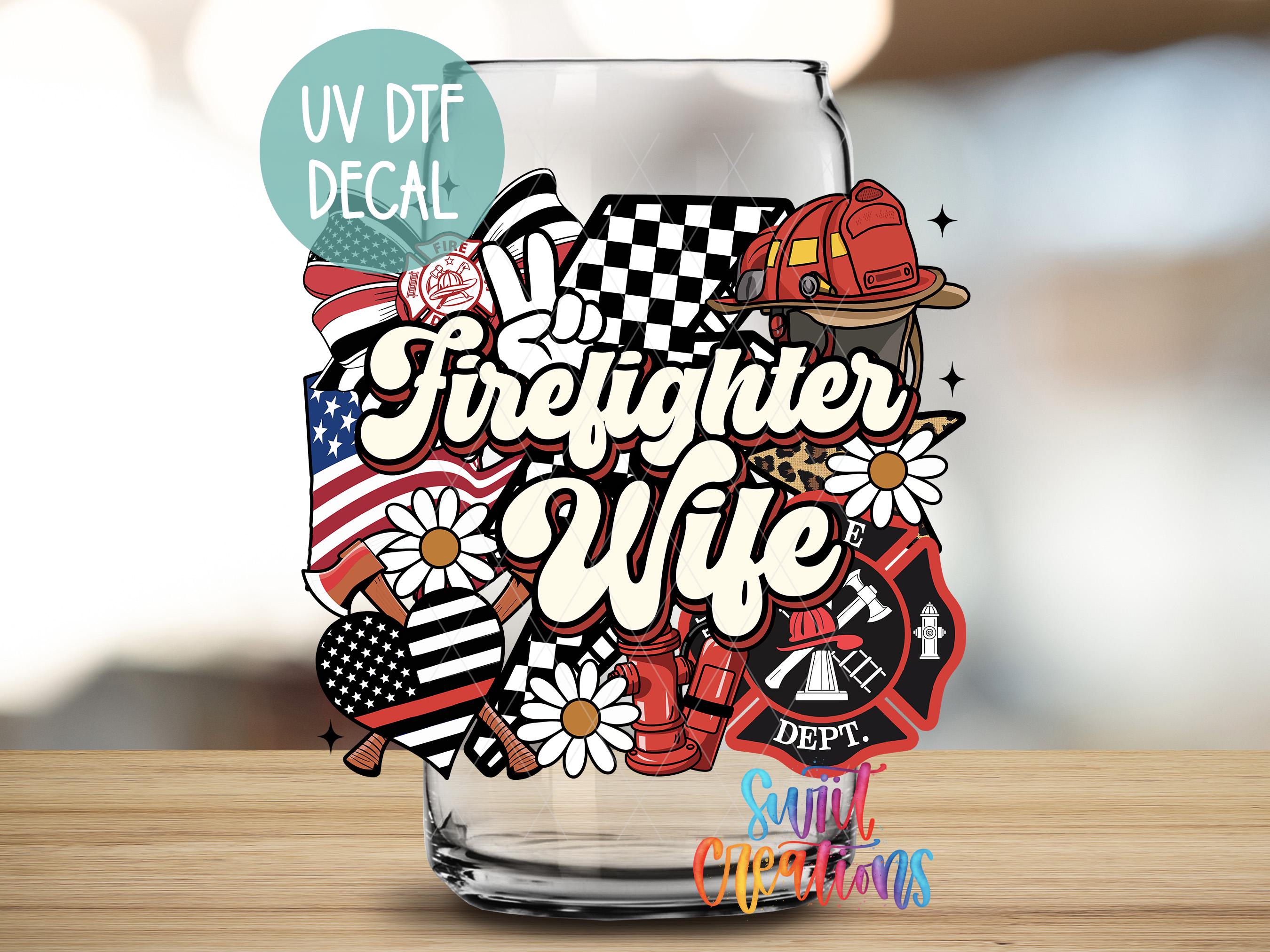 a glass with some stickers on it sitting on a table