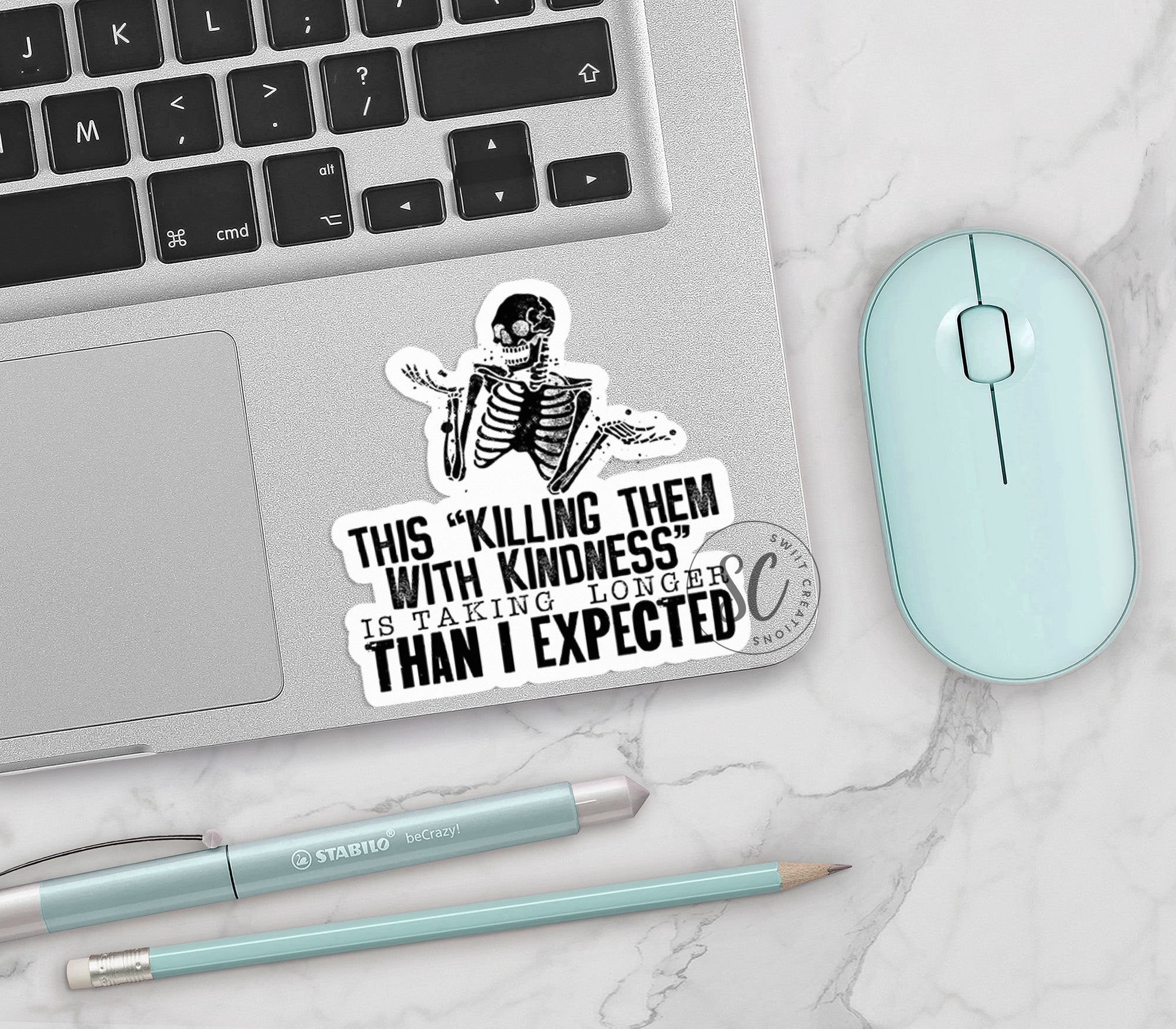 a laptop with a sticker of a skeleton on it