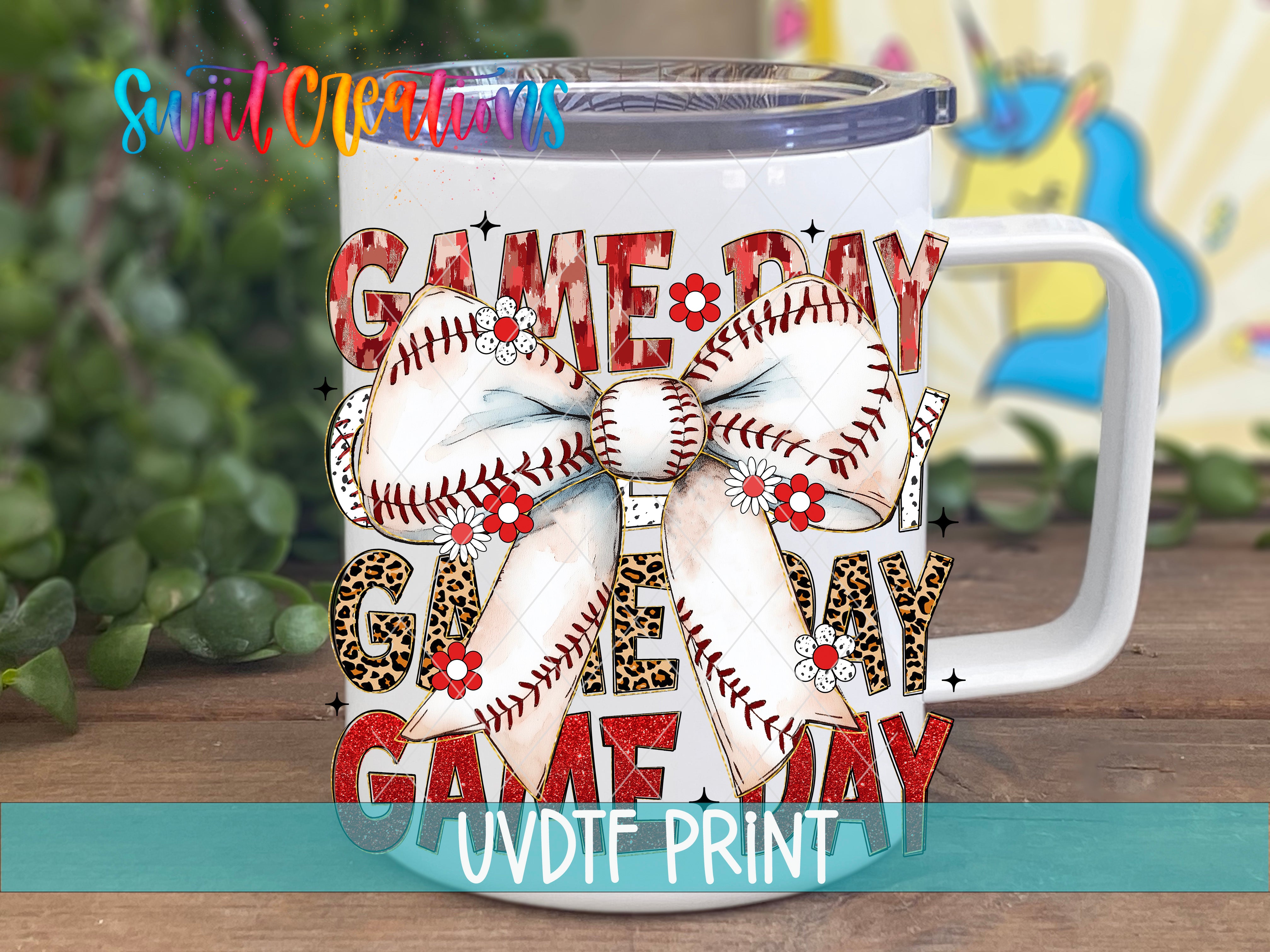 A white mug with a colorful design featuring baseball-related text and imagery, including a large bow made of baseballs and flowers.