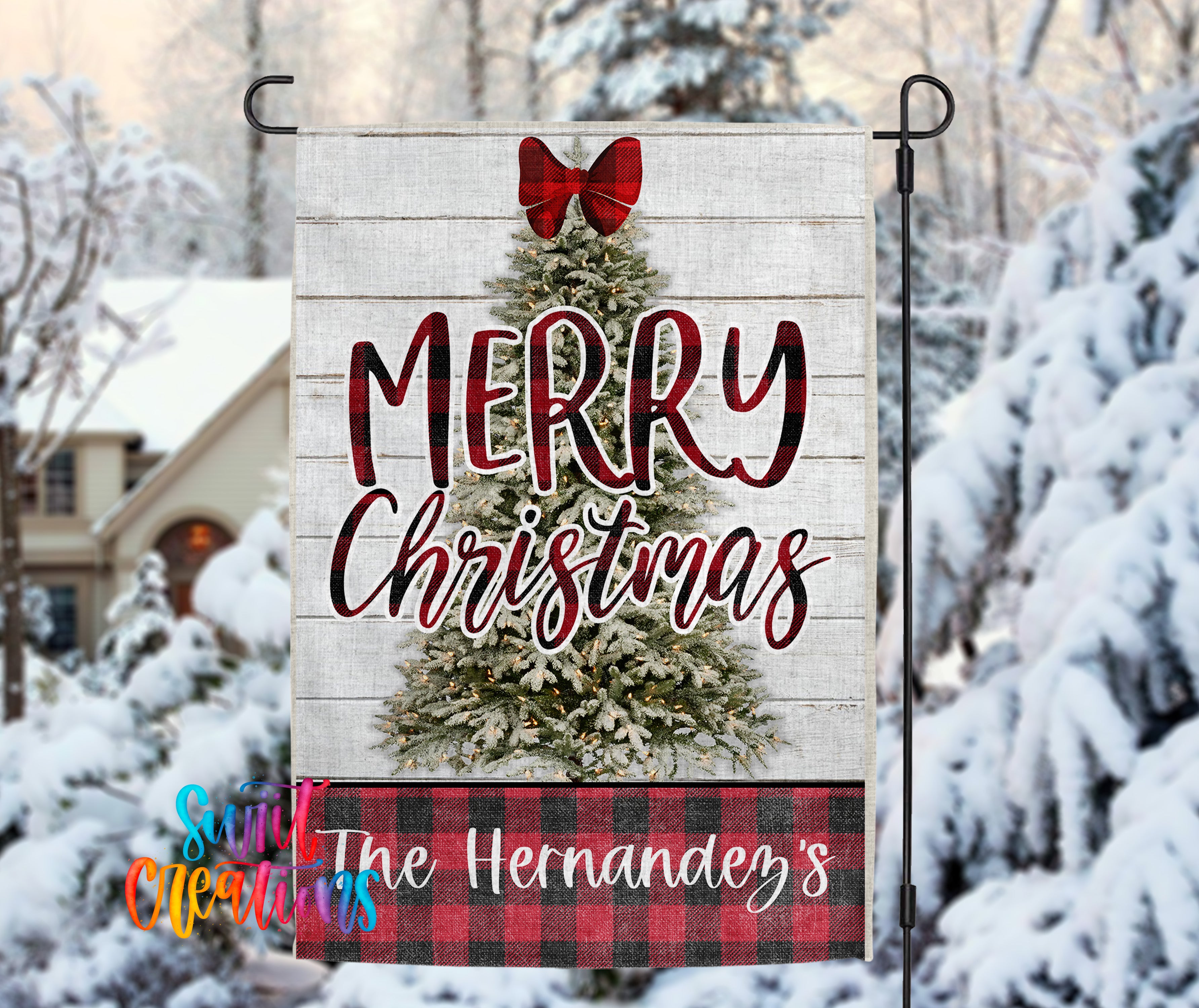 A wooden Christmas tree with a red bow, surrounded by snow-covered trees, with a banner that says "MERRY CHRISTMAS" and "The Hernández's" below it.