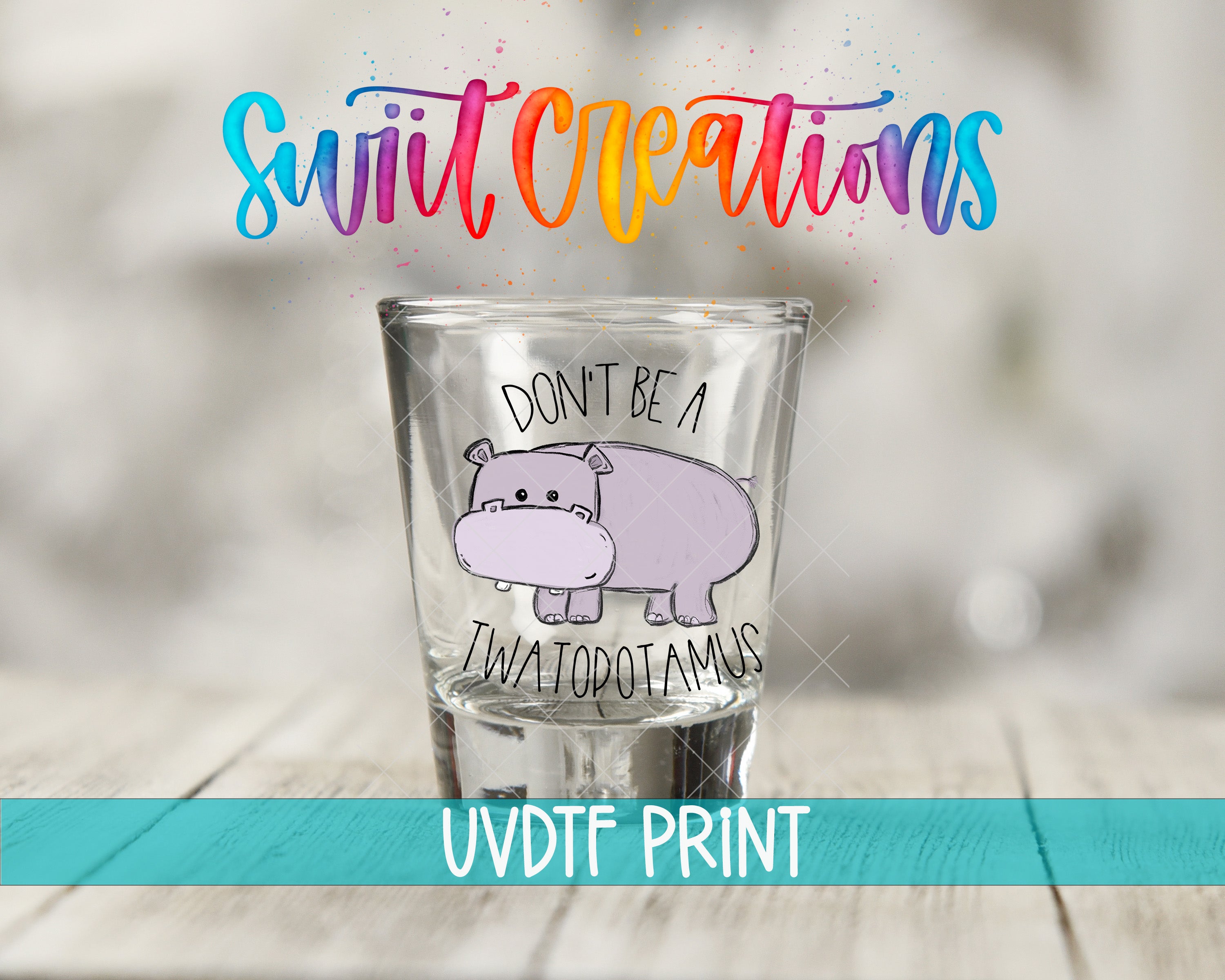 A shot glass with a cartoon hippopotamus and the text "DON'T BE A TWATOPOTAMUS" printed on it.