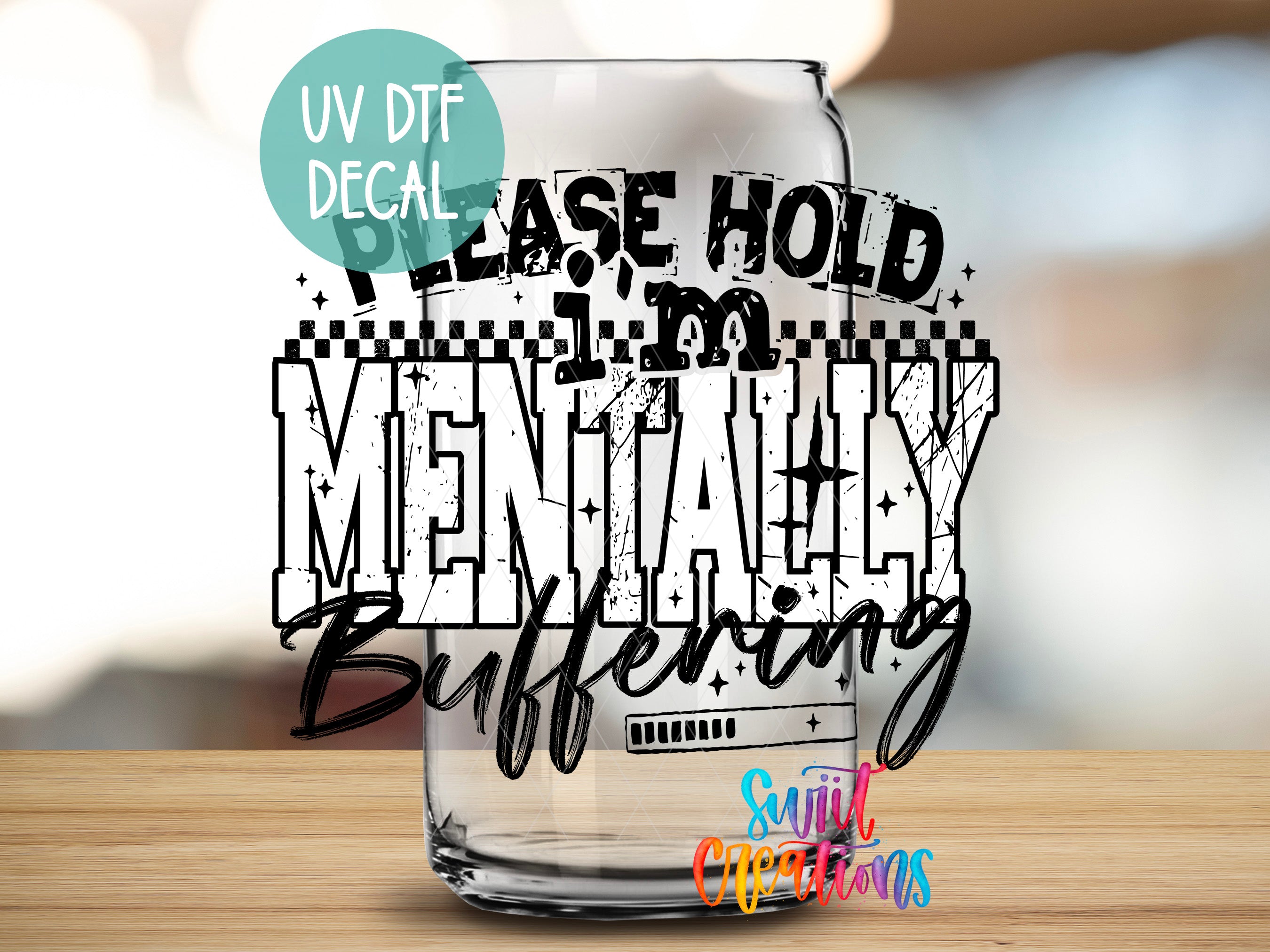 a glass with a humorous text decal on it, which reads "Please hold mentally buffering".