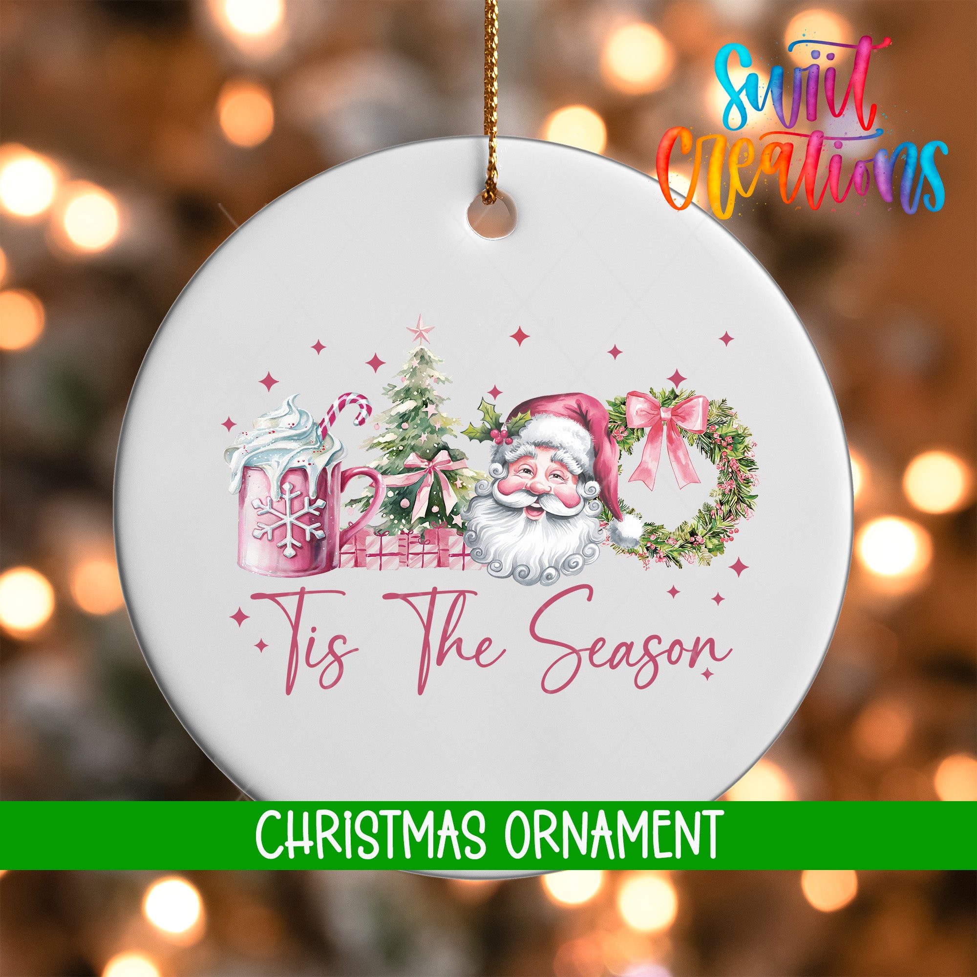 A white Christmas ornament with a Santa Claus design and the text "Tis the Season!" hanging from a string.