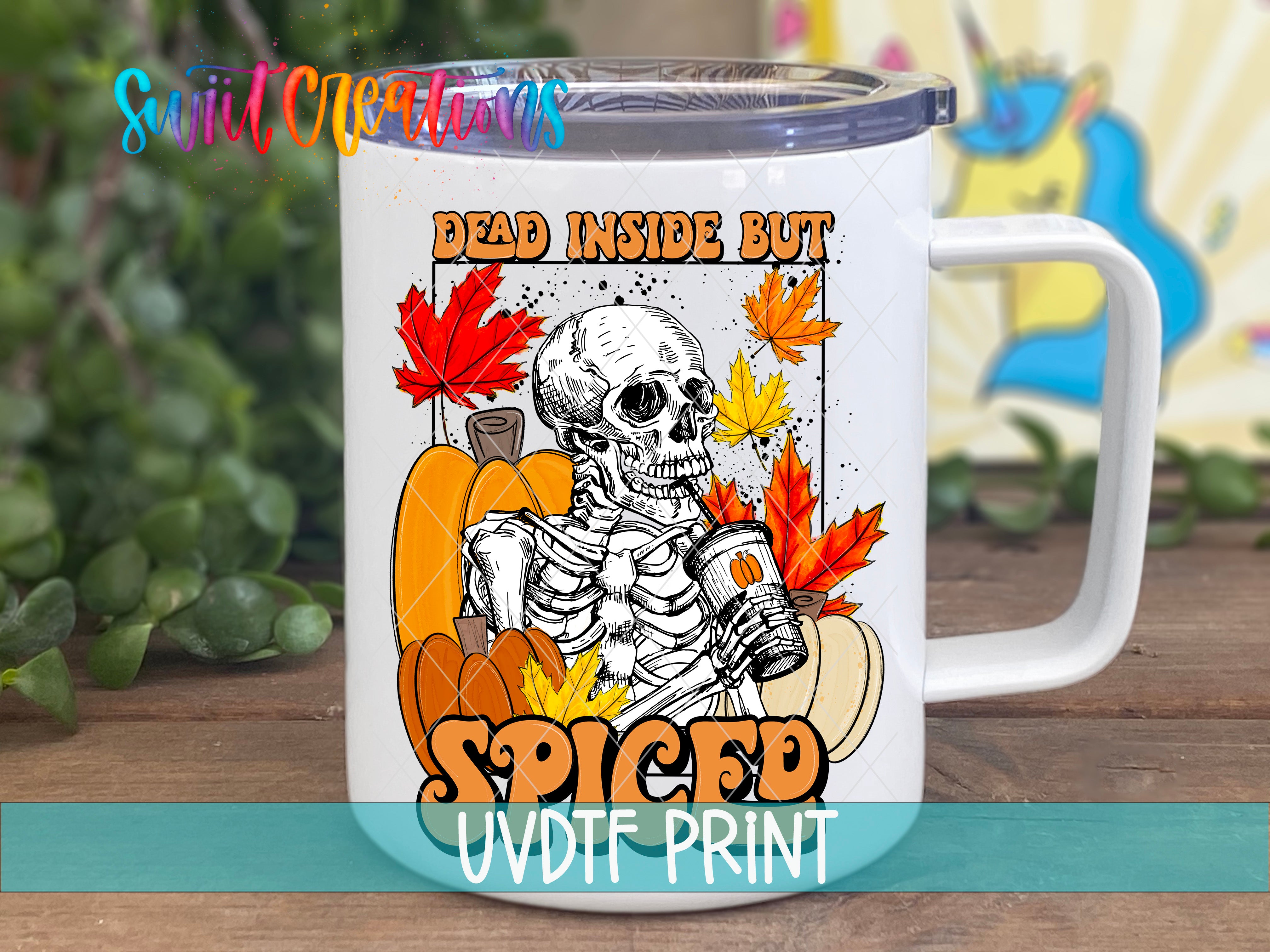 A white mug with a colorful design featuring a skeleton holding a cup, surrounded by autumn leaves and pumpkins.