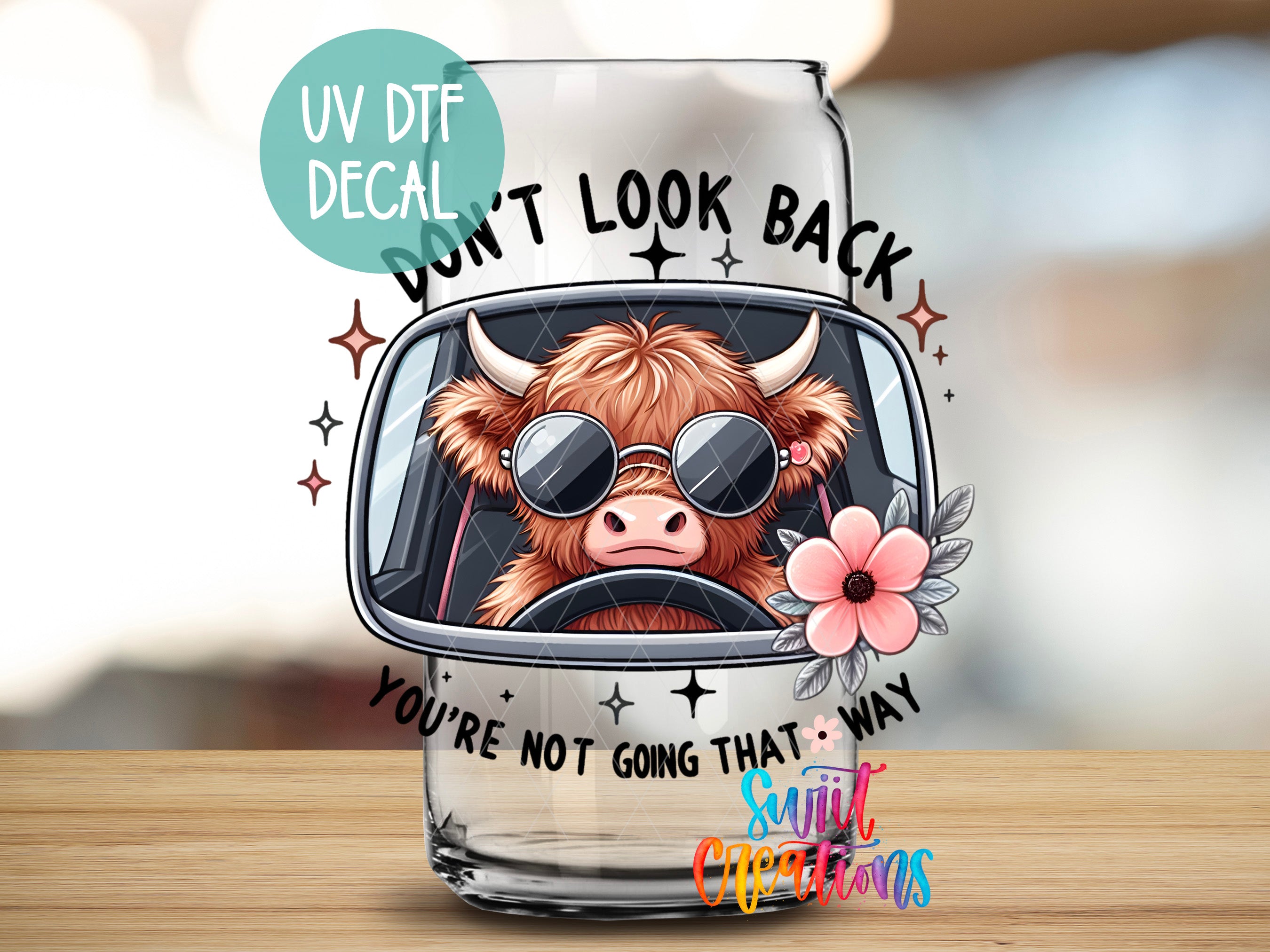 a glass with a picture of a cow wearing sunglasses