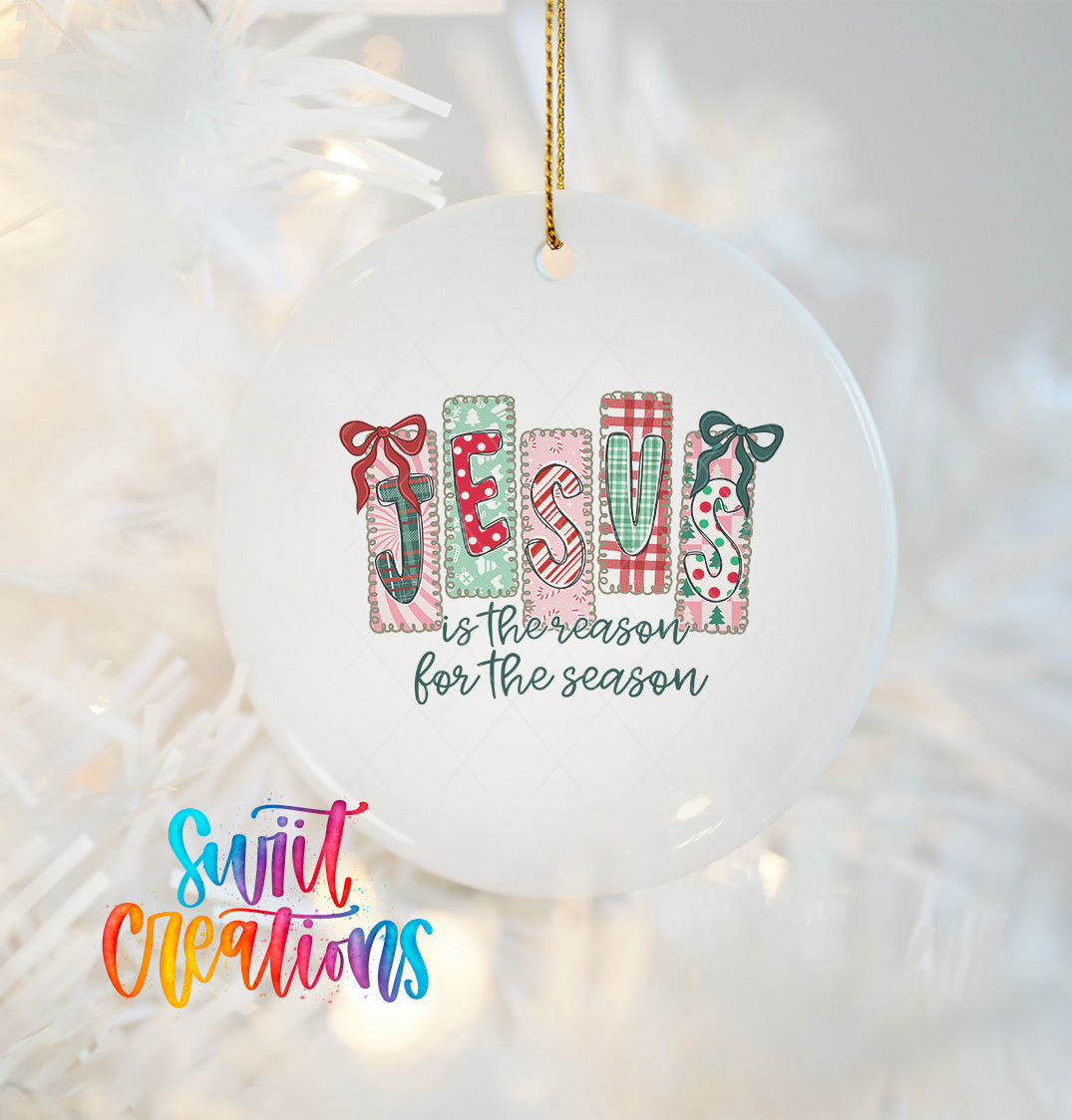 A white ornament with the word "JESUS" spelled out in colorful blocks, along with the text "is the reason for the season" written below.