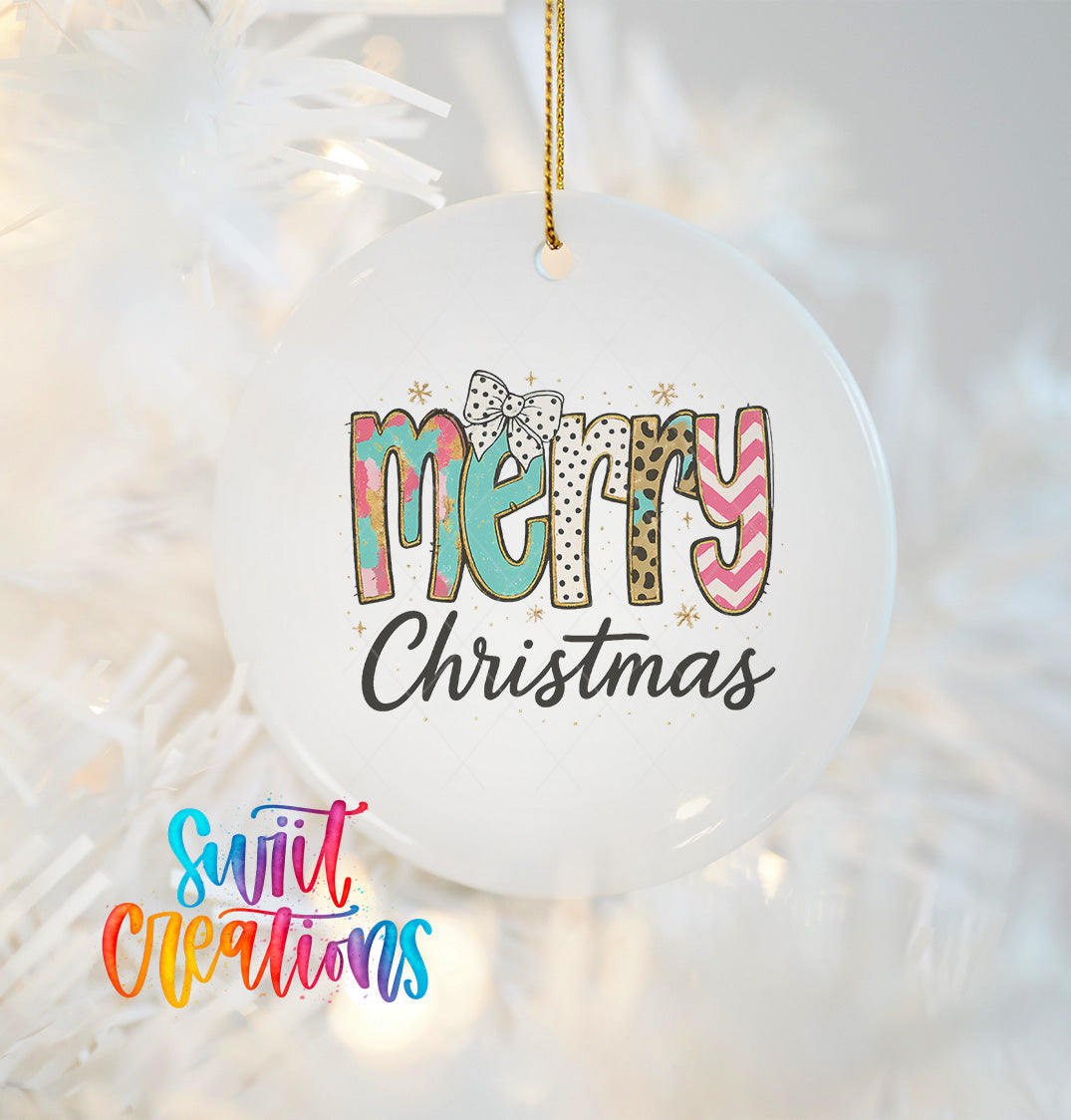 A white Christmas ornament with the text "MERRY CHRISTMAS" printed on it, hanging on a tree.
