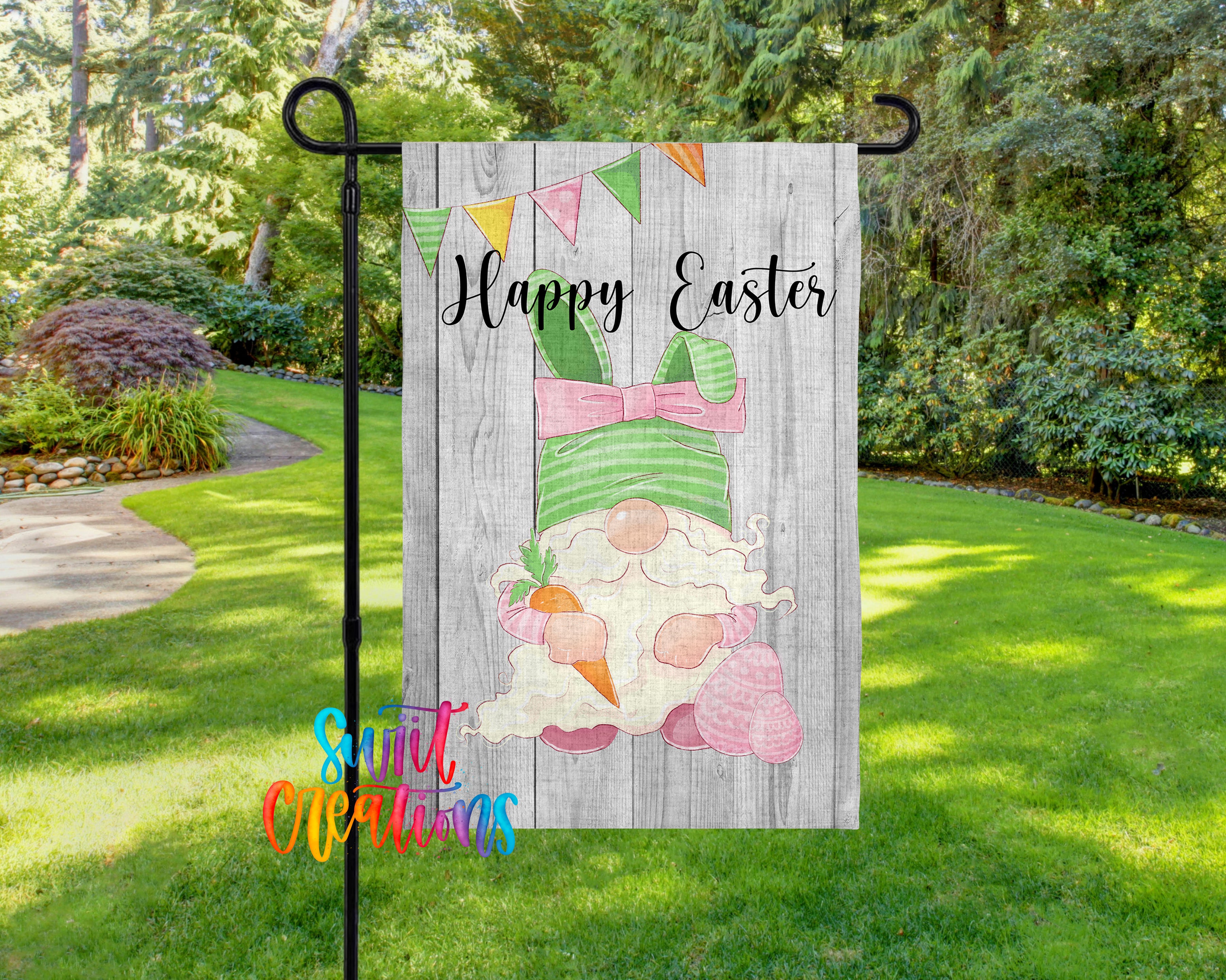 A garden sign featuring a cartoon gnome holding a carrot and the text "Happy Easter" is displayed in a grassy area surrounded by trees.