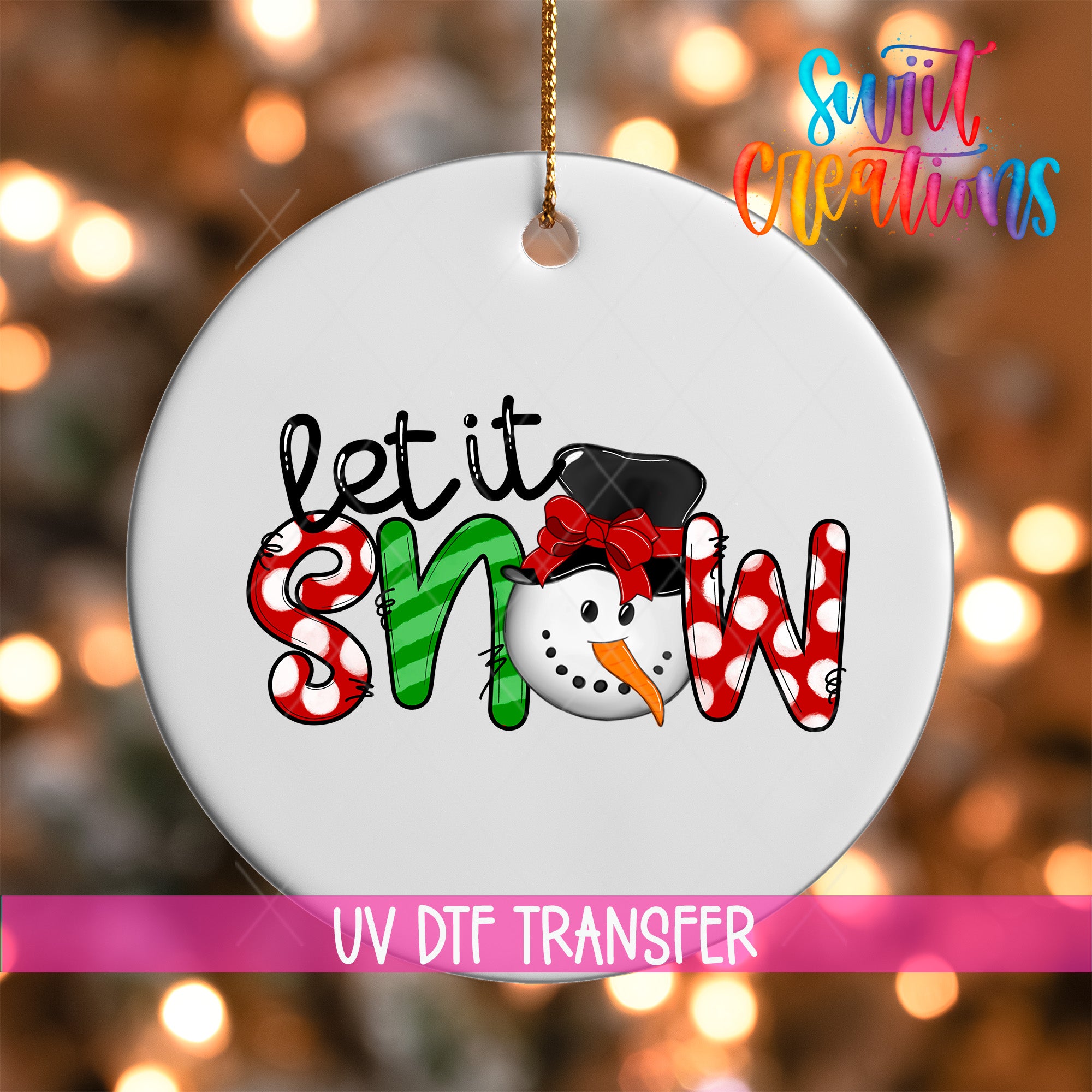 A white ornament with the text "let it snow" and a snowman graphic, hanging against a background of colorful lights.