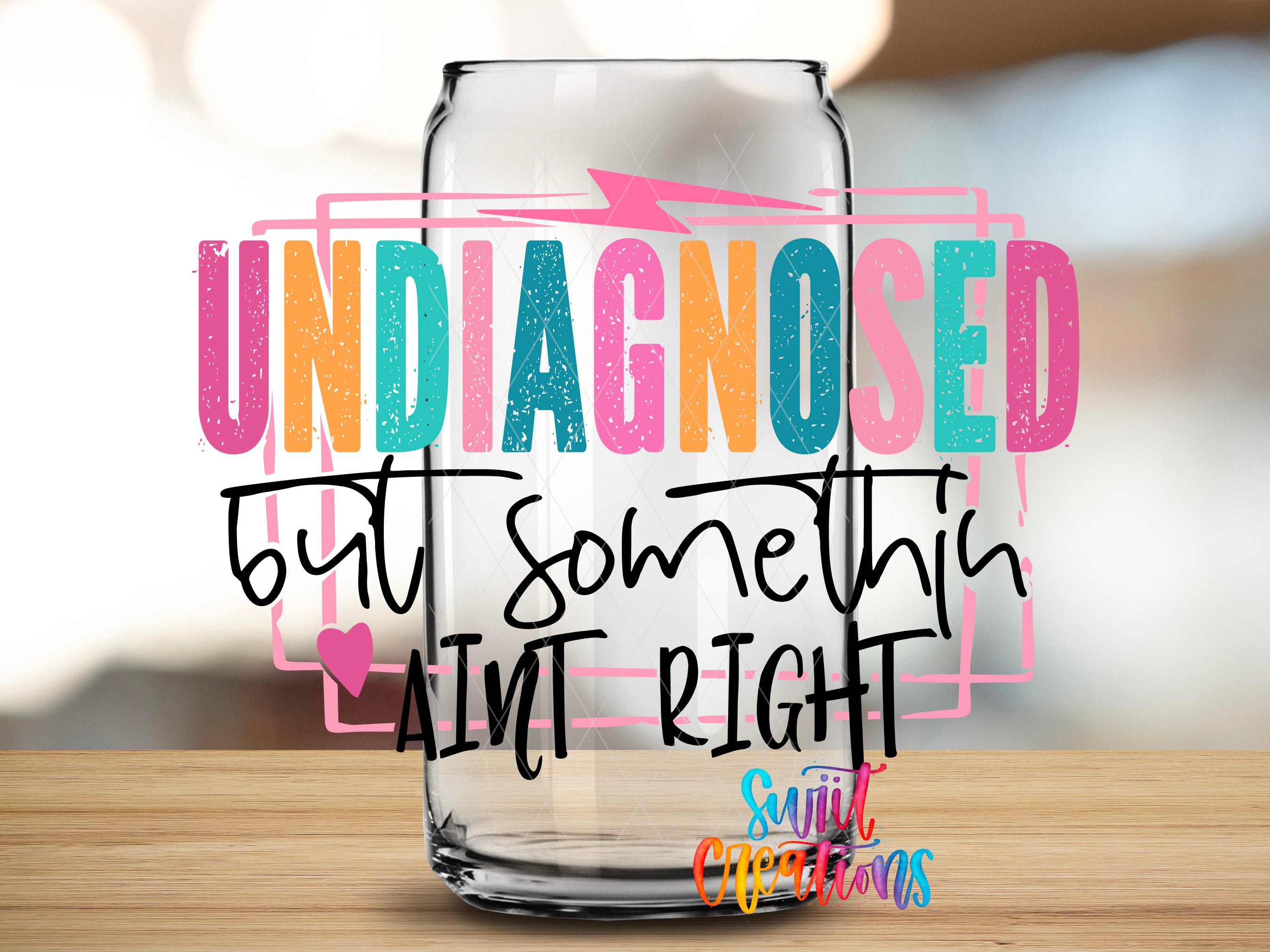 a colorful text overlay on a glass can, which reads "UNDIAGNOSED butt something AIN'T RIGHT" in a playful and humorous manner.
