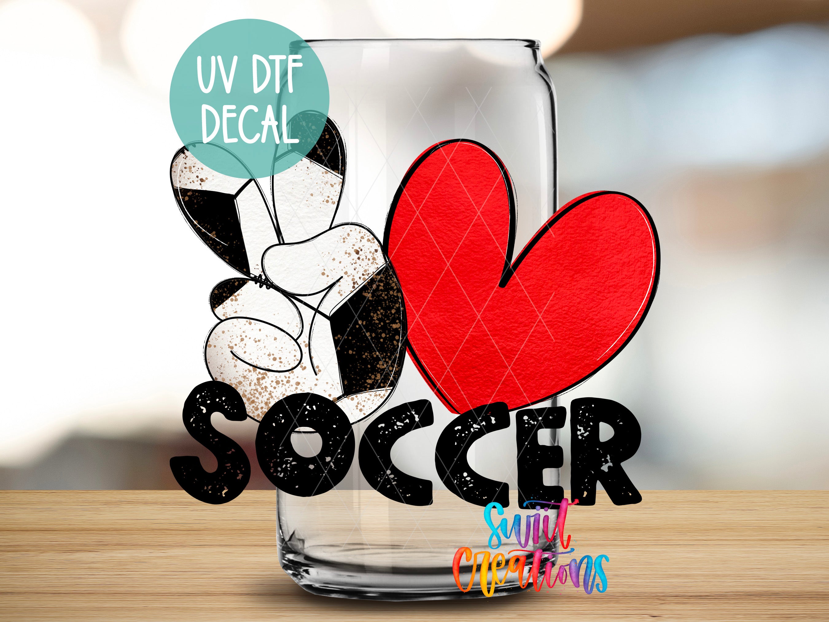 a glass with a soccer ball and a heart, along with the word "SOCcer" written on it.