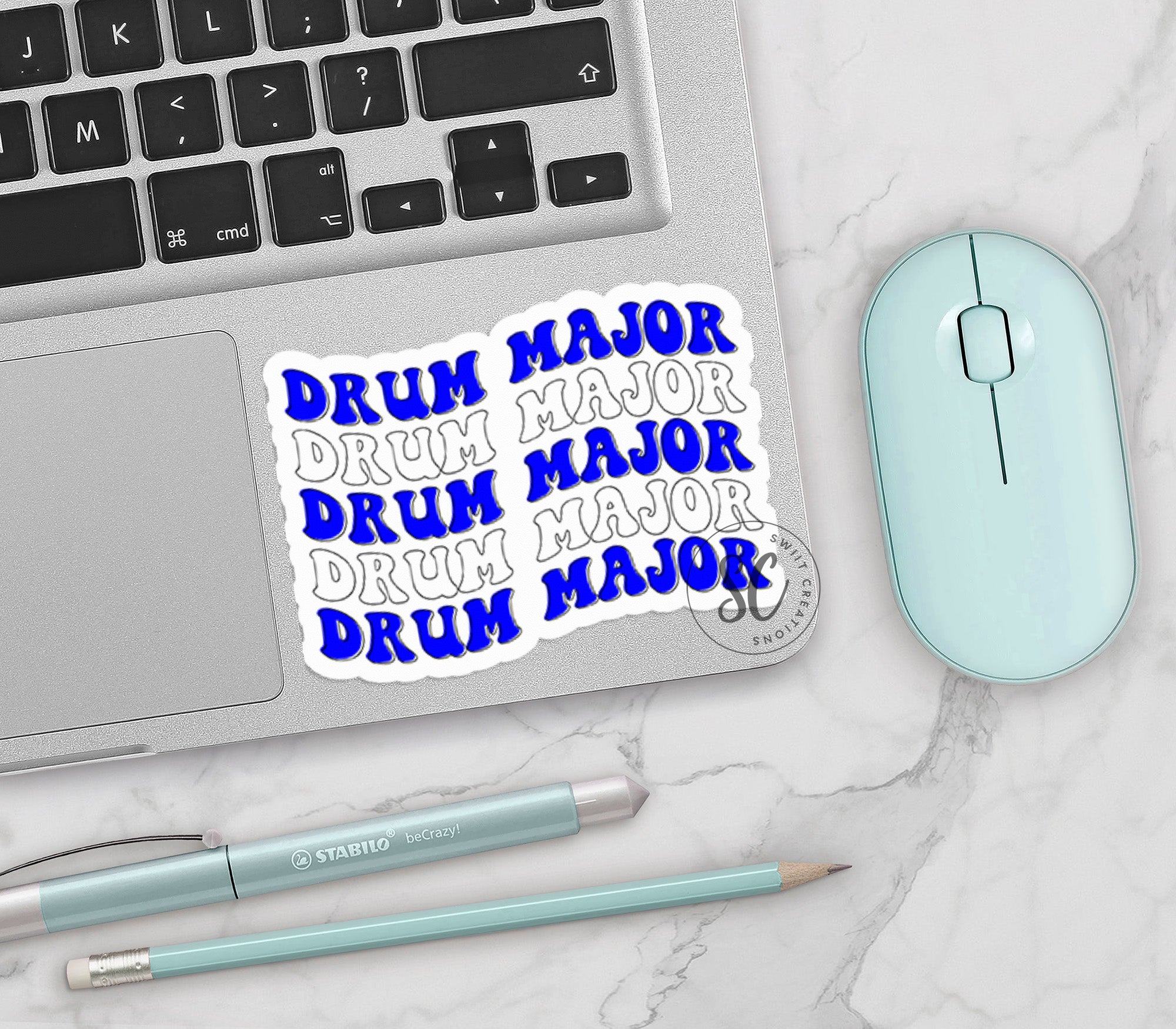 a keyboard, mouse, and sticker on a table