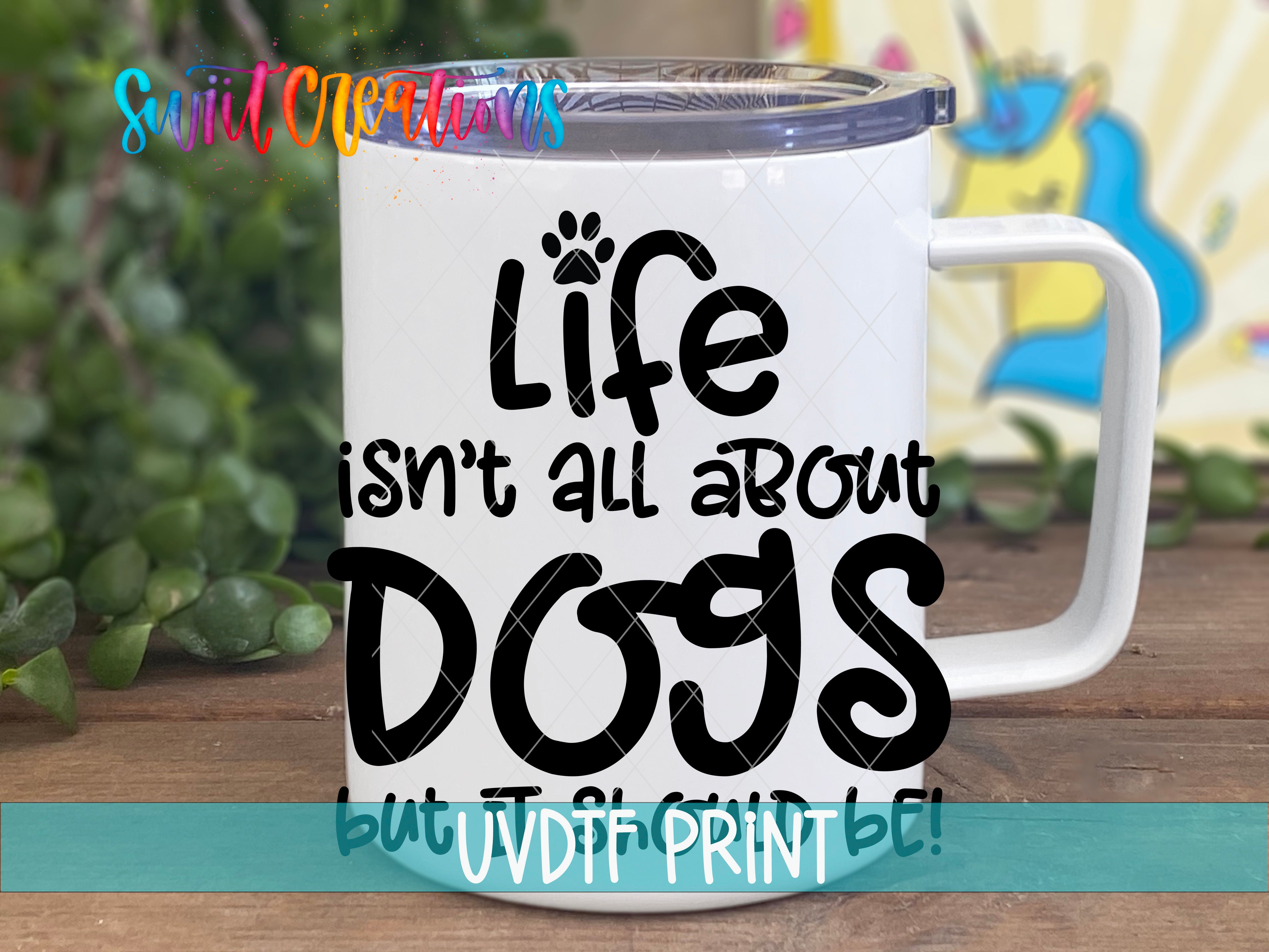 A white mug with a printed message that reads "Life isn't all about dogs but JVDT PRINT" in black text.