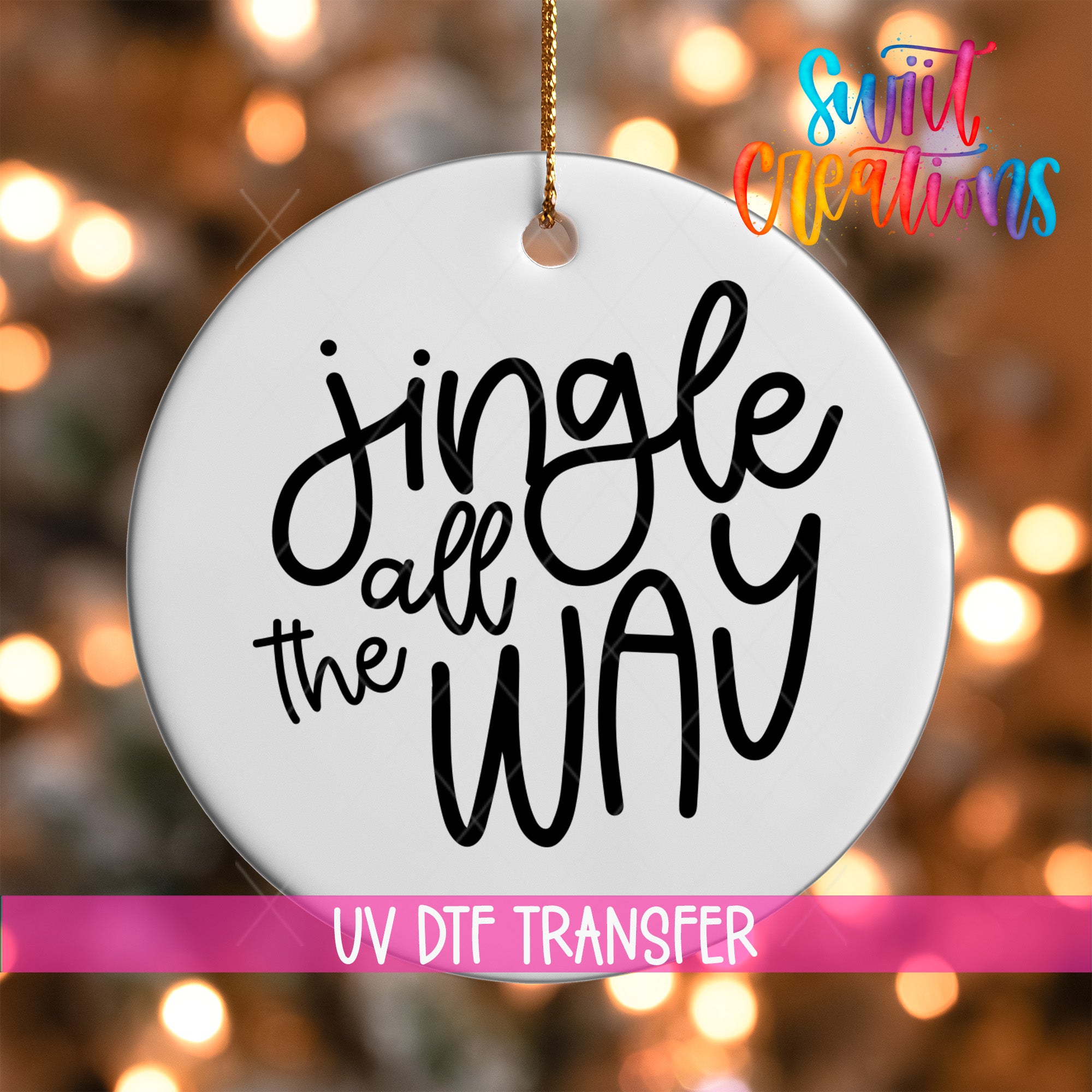 A white ornament with the text "Jingle all the way" written on it, hanging against a background of colorful lights.