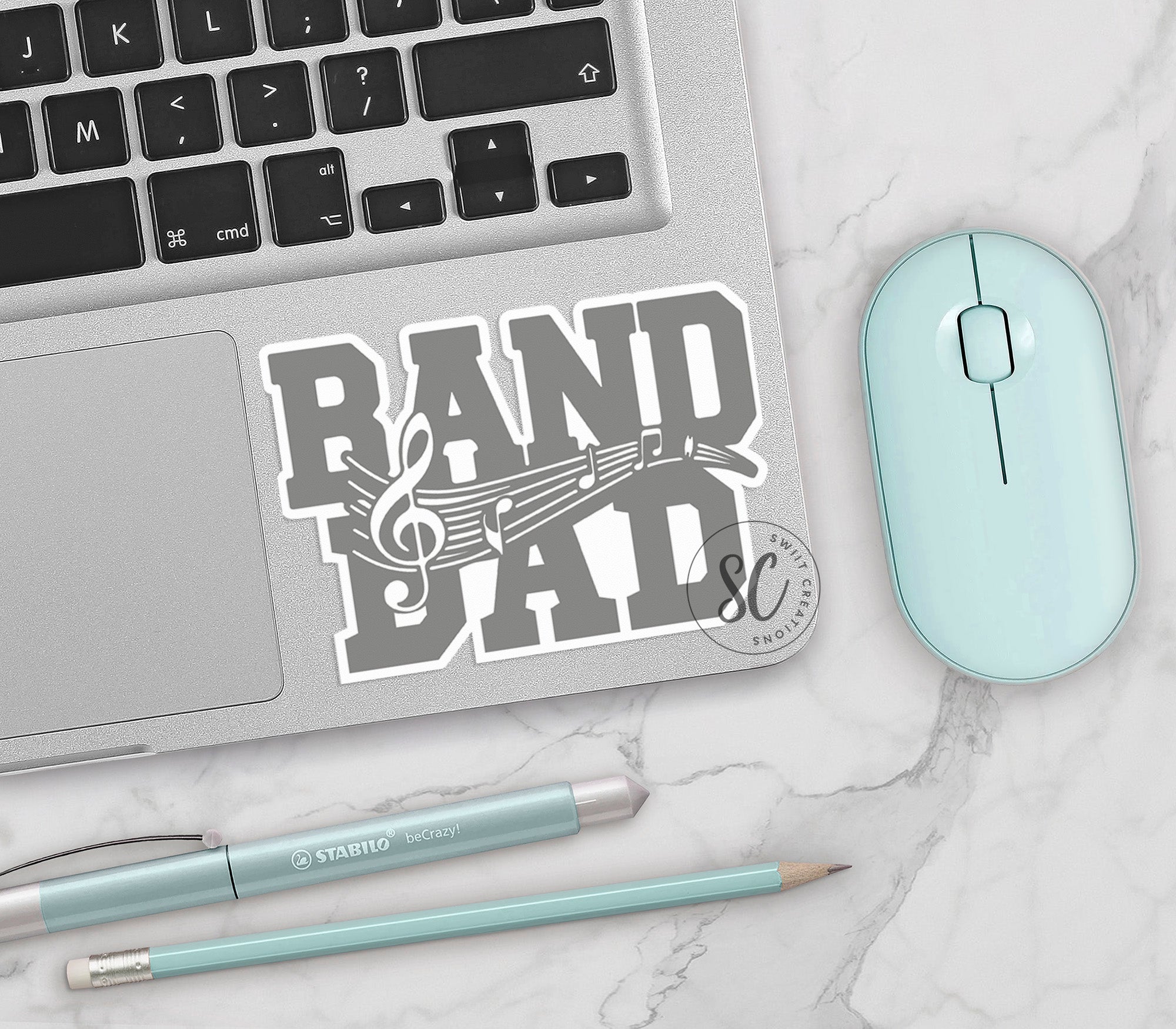 a keyboard, mouse, and sticker on a table