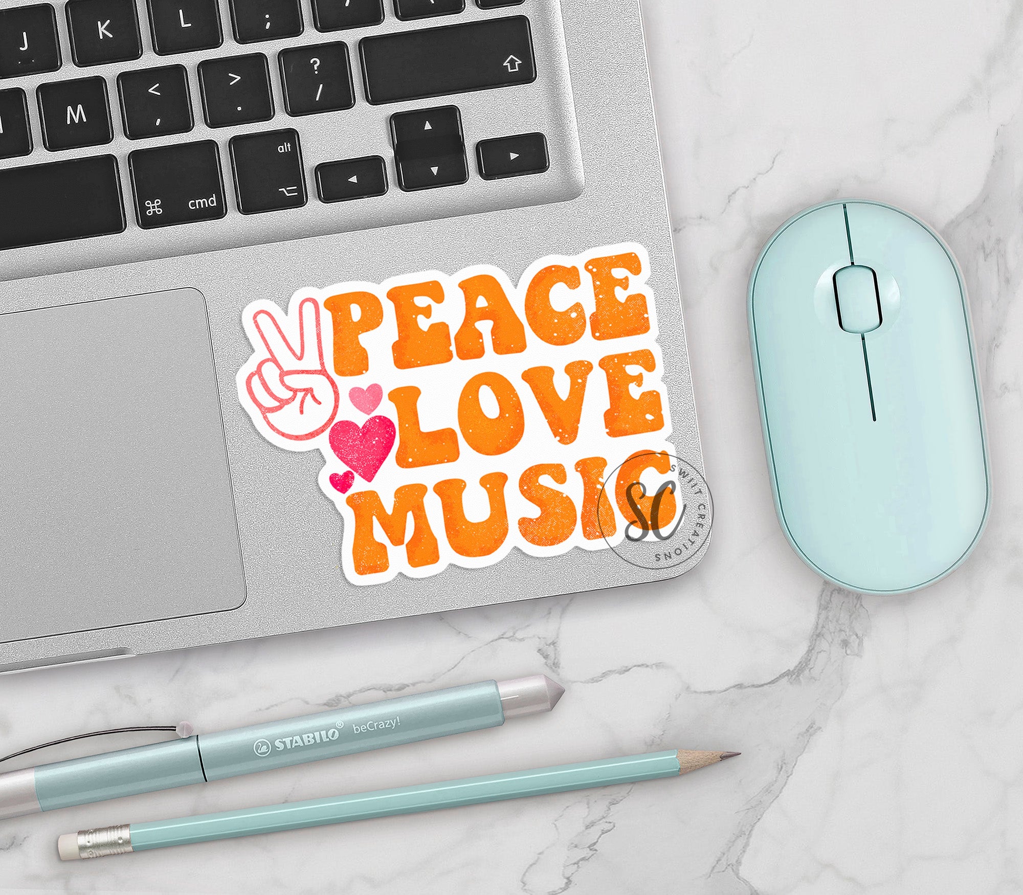 a laptop with a peace love music sticker on it