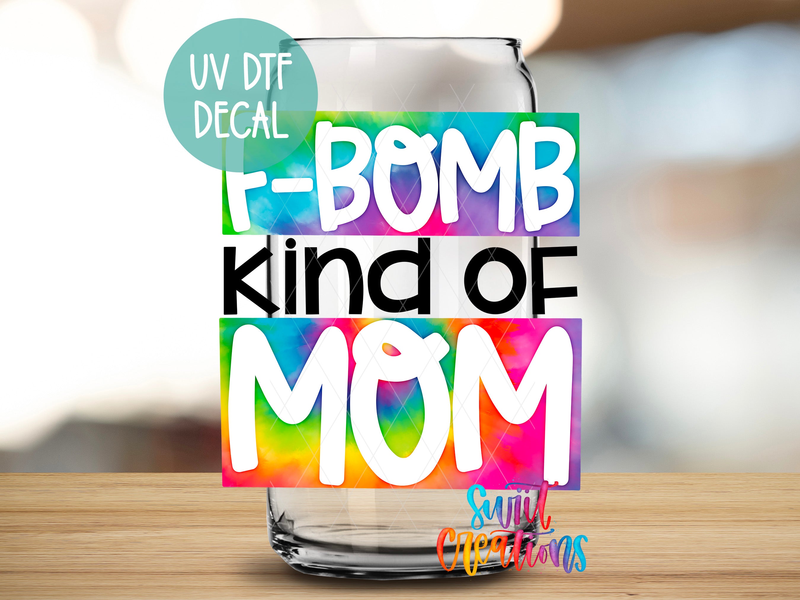 a glass with the words t - bomb kind of mom on it