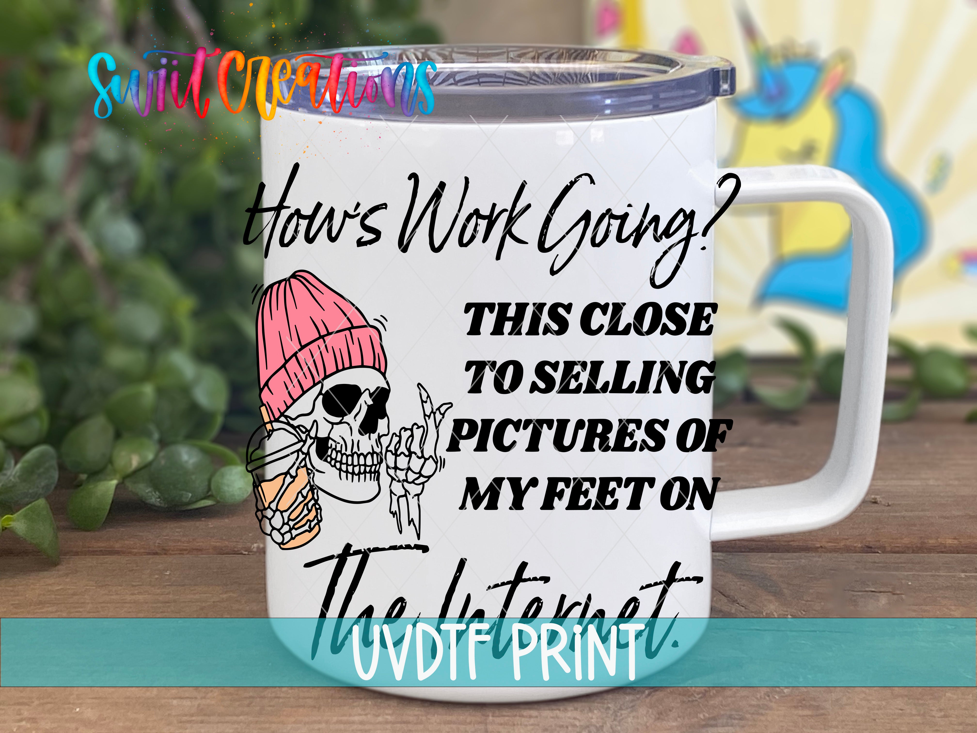 A white mug with a skeleton wearing a pink beanie and holding a drink, along with text that reads "How's Work Going? This Close to Selling Pictures of My Feet on the Internet."