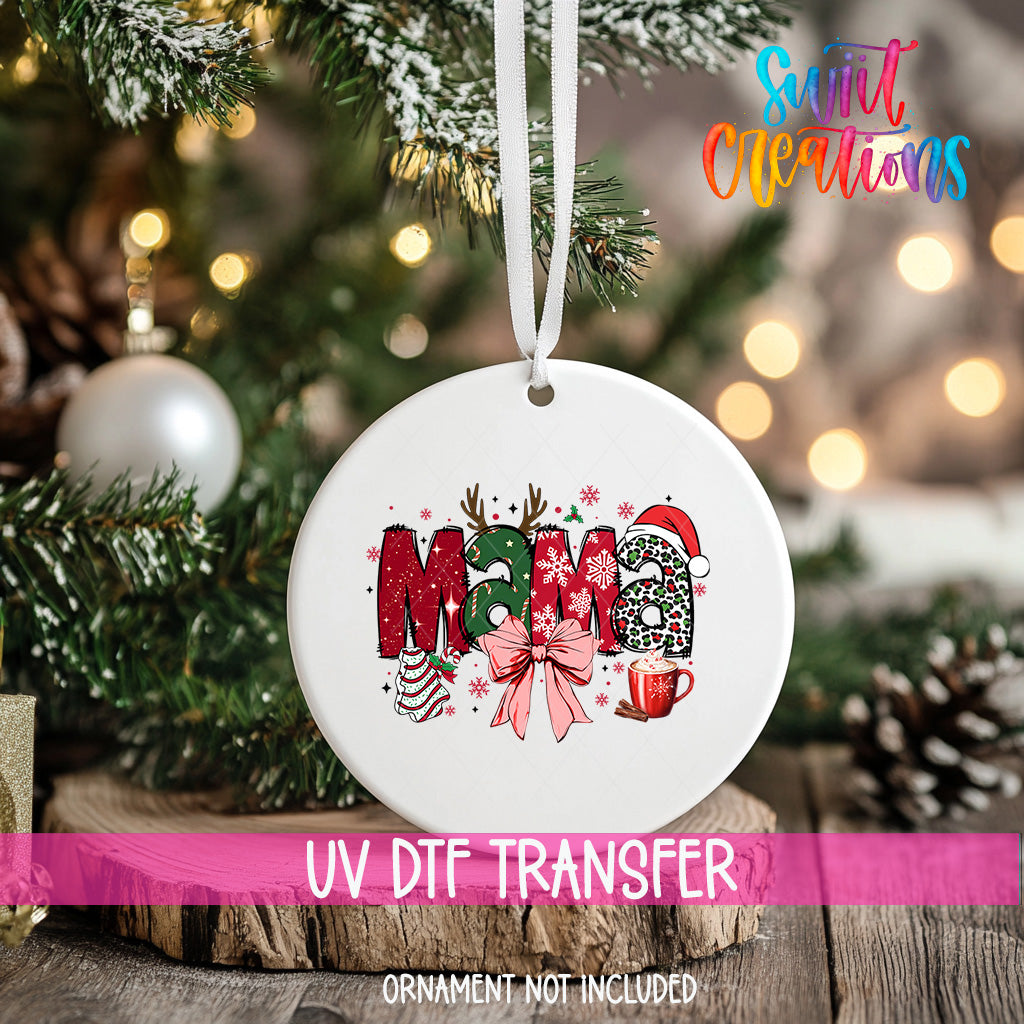 A white ceramic ornament with the word "Mama" written on it, hanging on a Christmas tree.