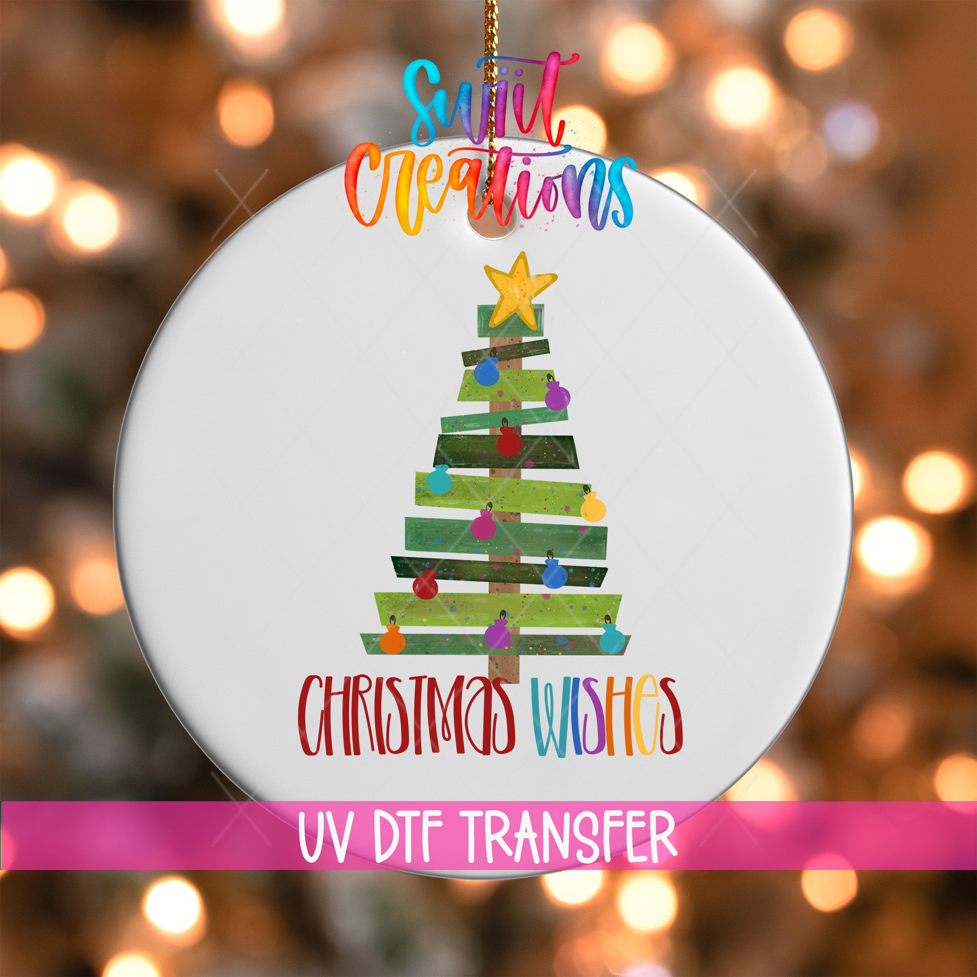 A white Christmas tree ornament with colorful lights and ornaments, hanging against a background of blurred lights.