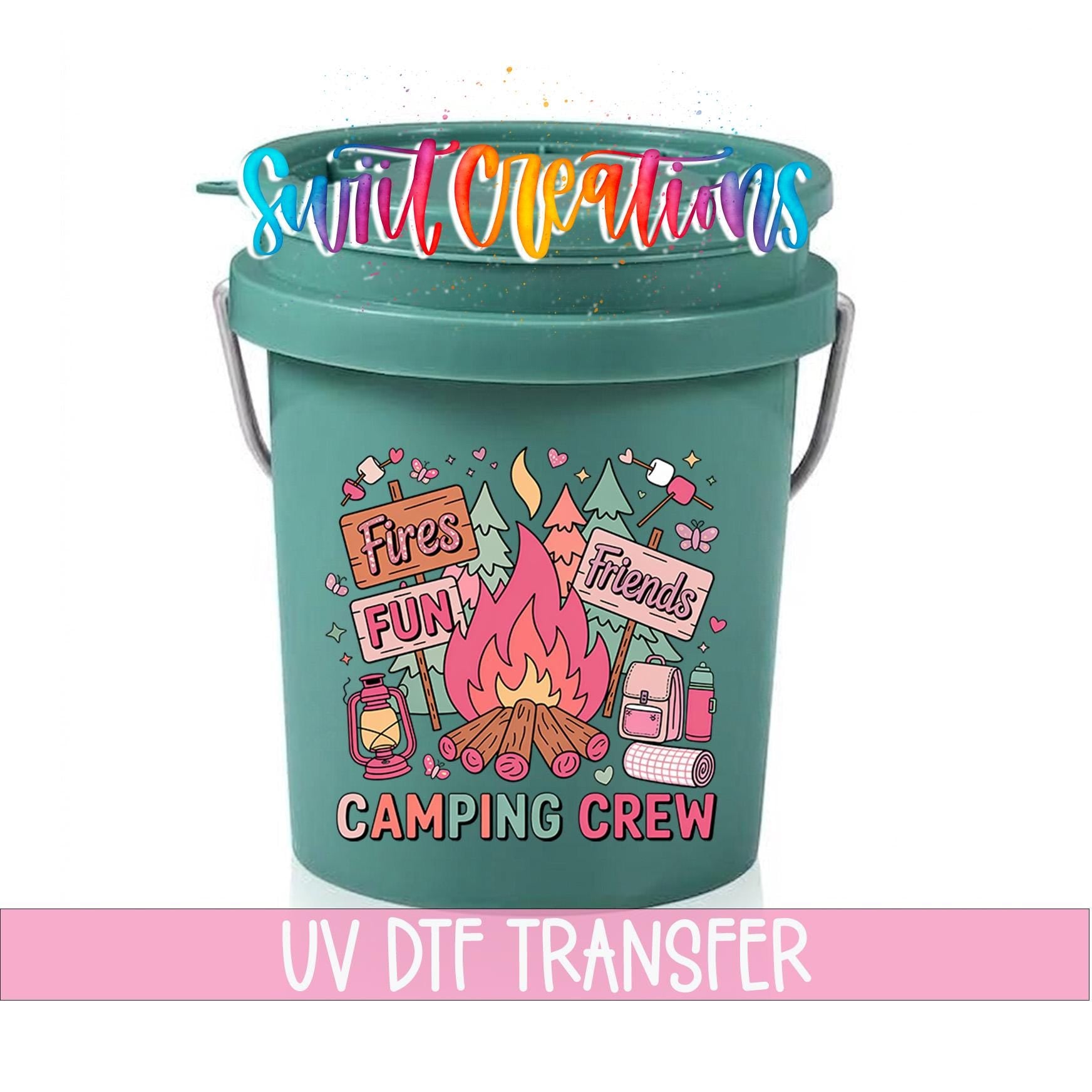 A green bucket with a colorful design featuring a campfire, camping gear, and text that says "Fires Fun Friends Camping Crew".