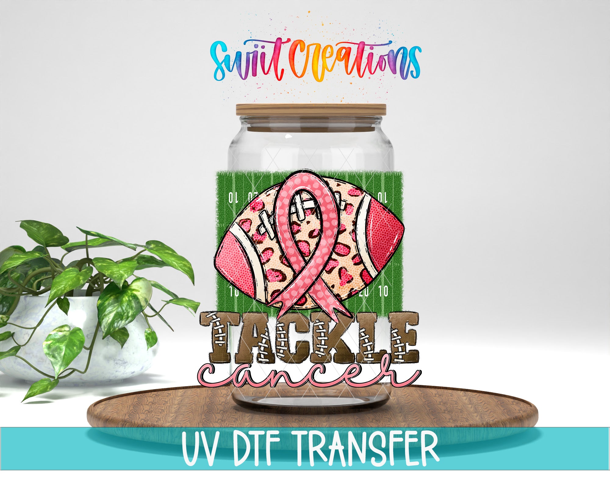 a glass jar with a football graphic and a pink ribbon, along with the text "TACKLE CANCER" and "Swift Creations" written above it. The jar is placed on a wooden surface, and there is a potted plant in the background.
