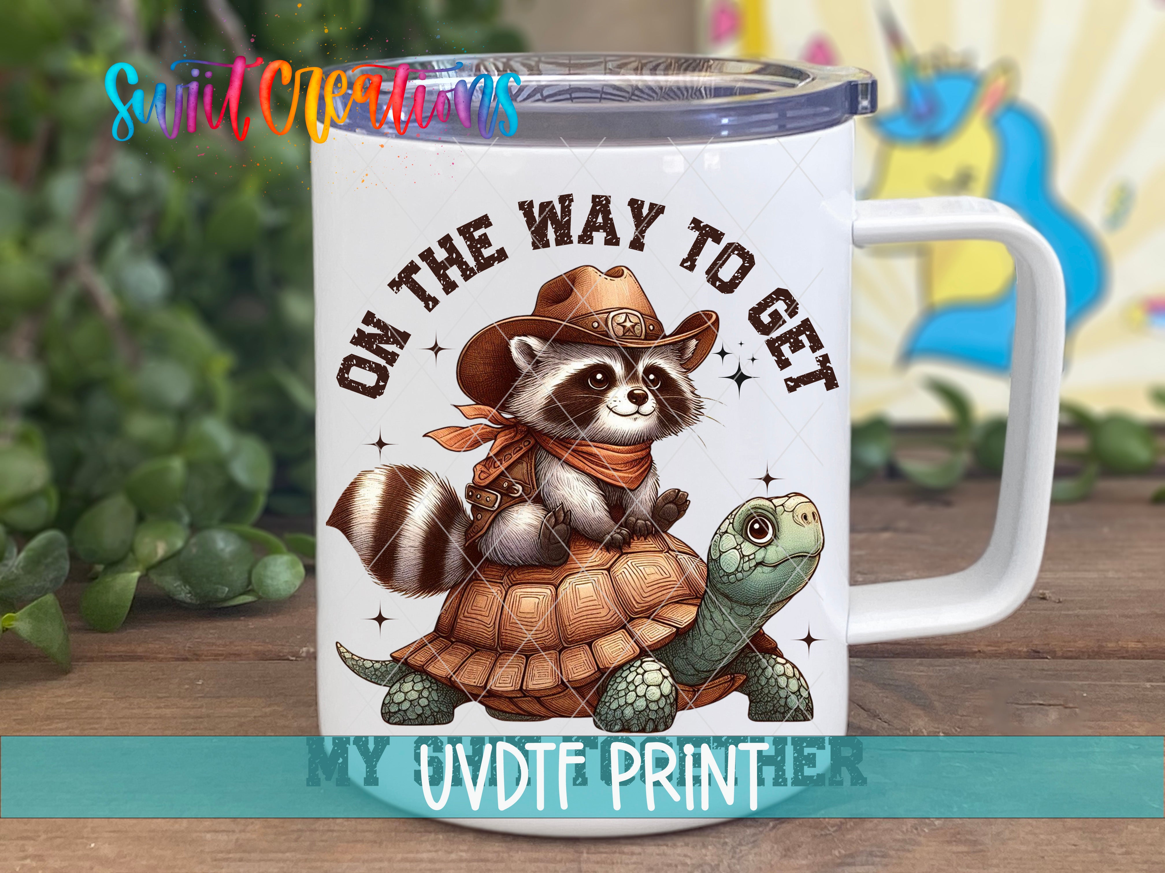 A mug with a cartoon image of a raccoon wearing a cowboy hat and riding a turtle.