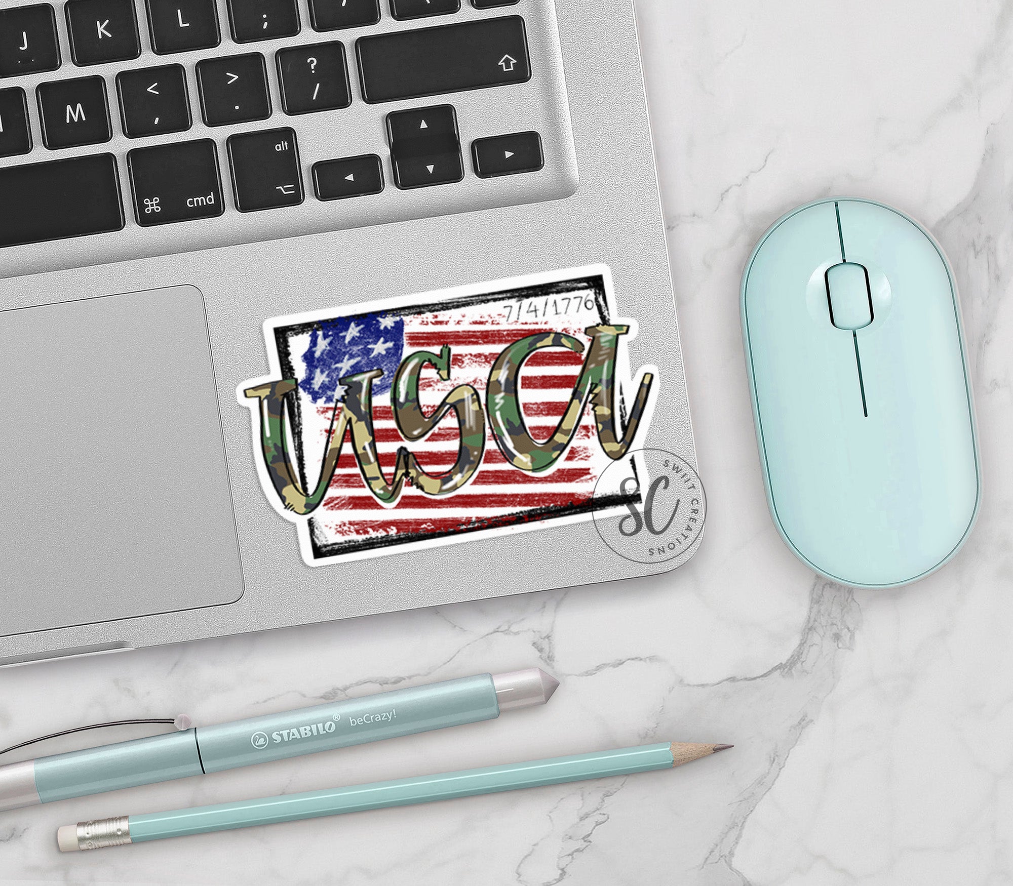 a laptop computer sitting on top of a desk next to a mouse