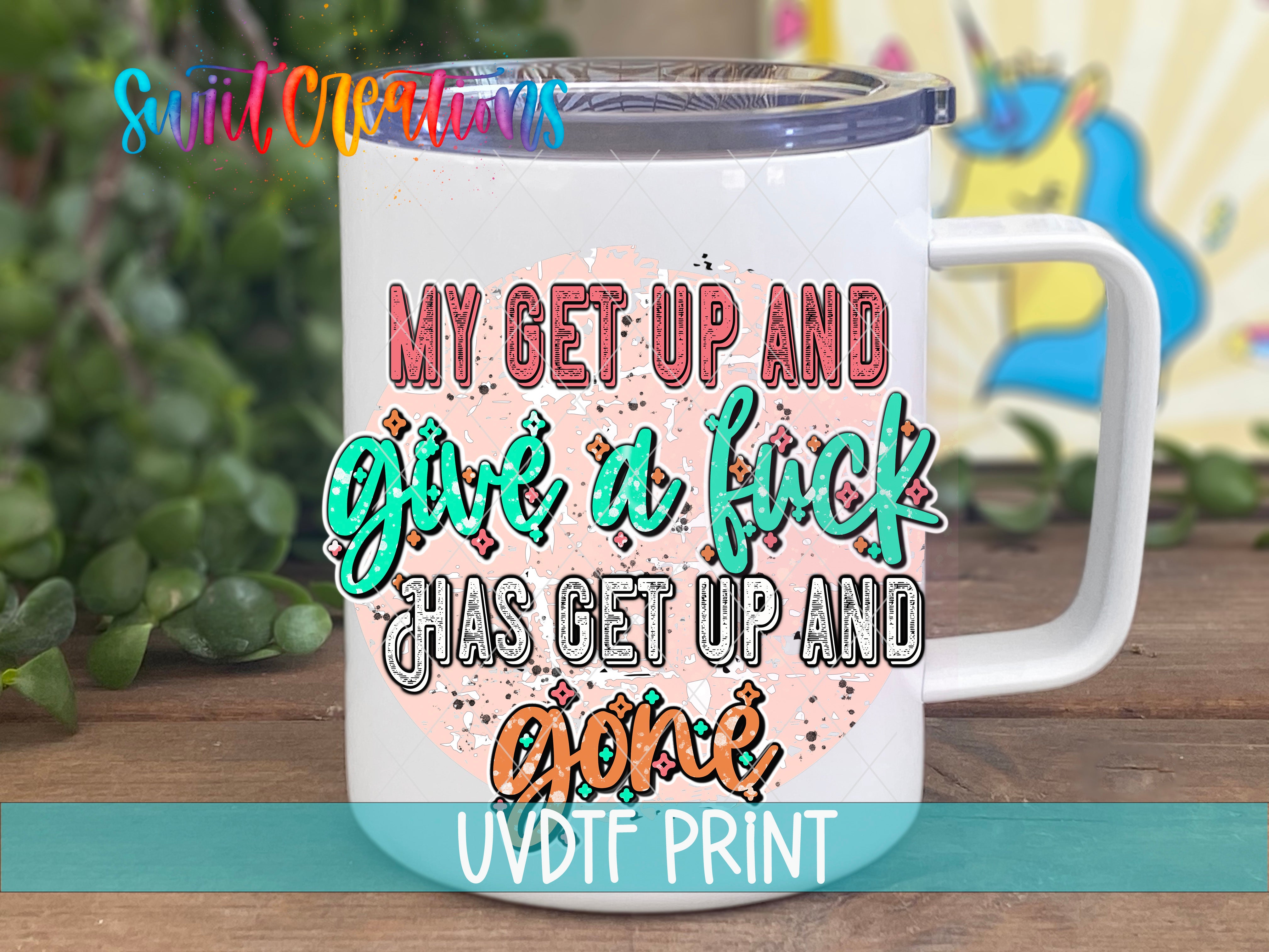 A white mug with colorful text and graphics on it, placed on a wooden surface.