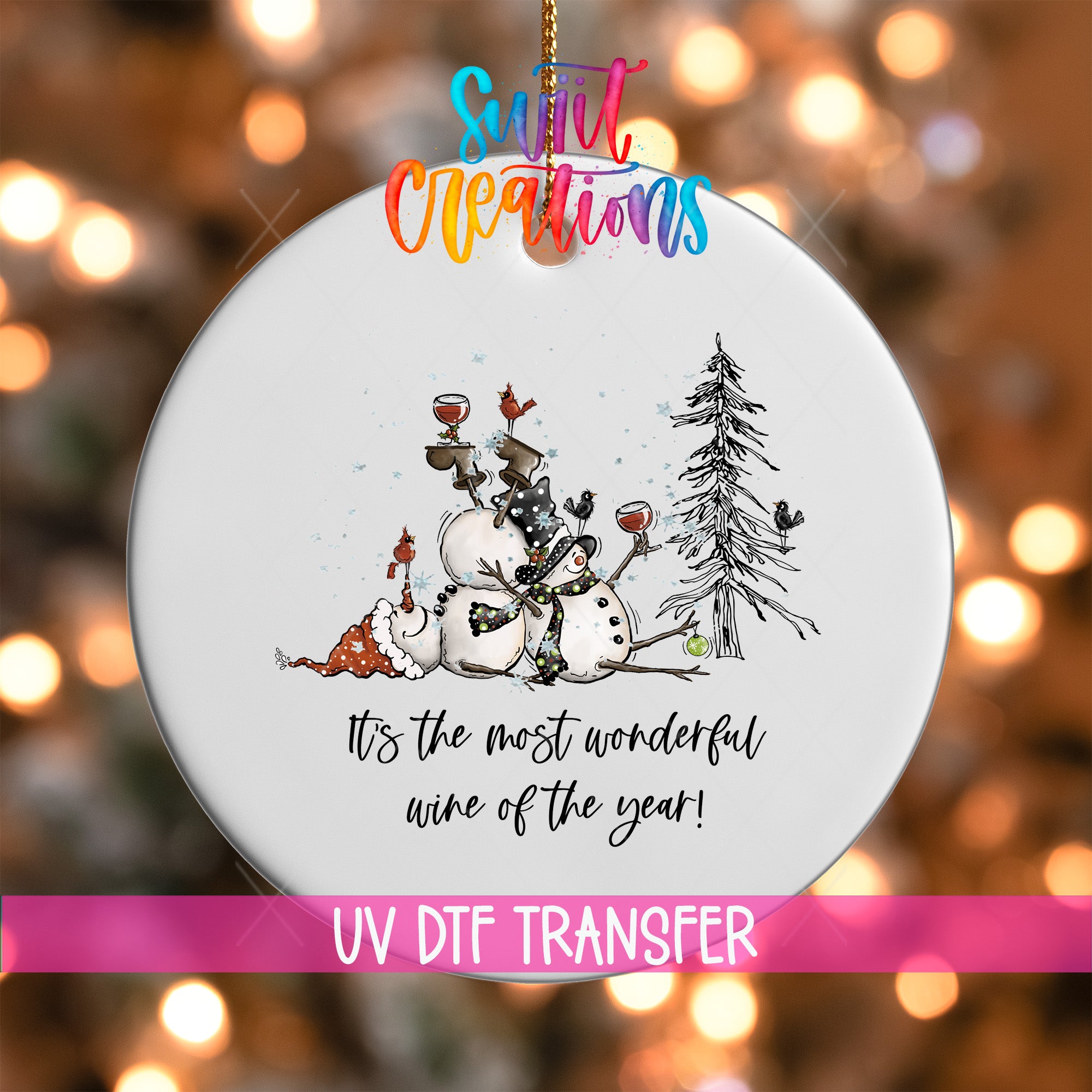 A white ornament with a snowman, a bird, and a tree, along with the text "It's the most wonderful wine of the year!" and "UV Dtf Transfer".