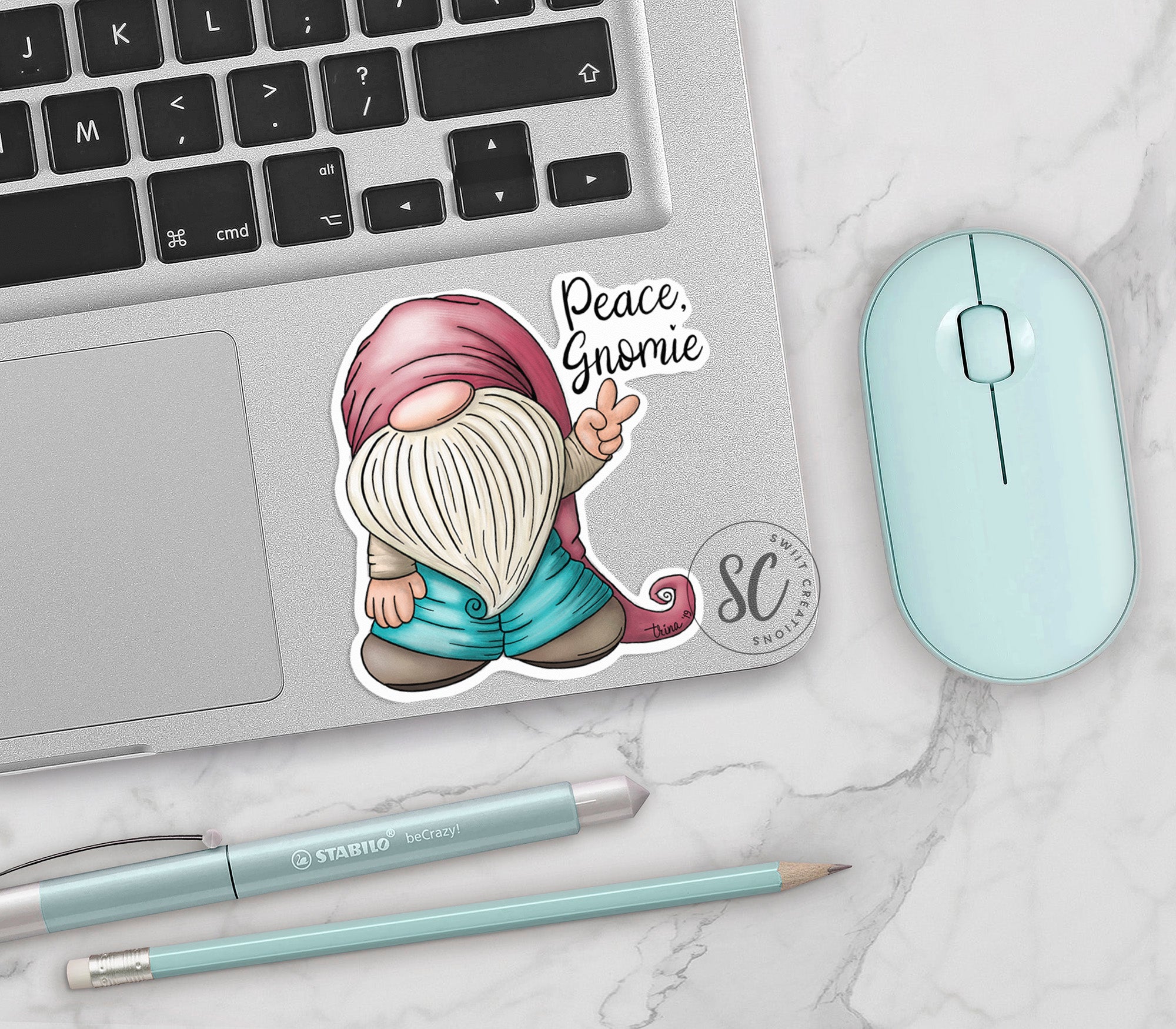 a laptop with a sticker of a gnome on it