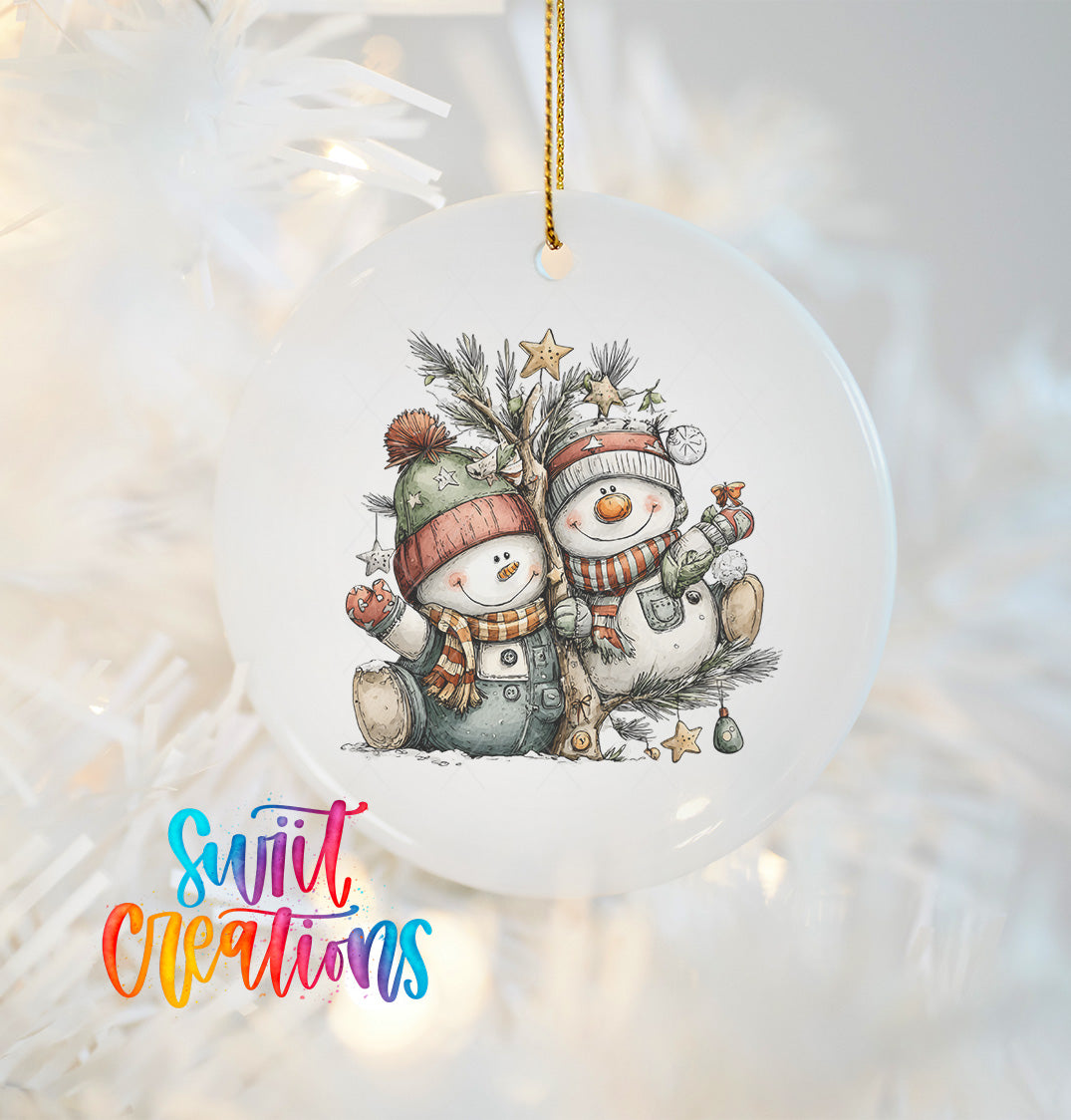 A white ornament with a snowman and a tree, featuring a pair of snowmen wearing winter hats and scarves.