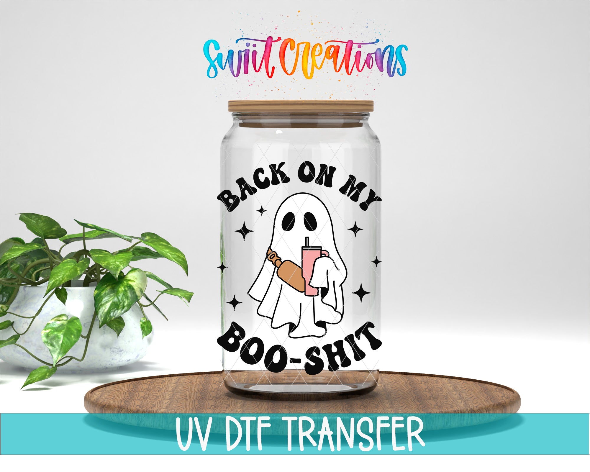 a glass jar with a cartoon ghost holding a sign that says "BACK ON MY BOO-SHIT". The jar is placed on a wooden surface, and there is a potted plant in the background.