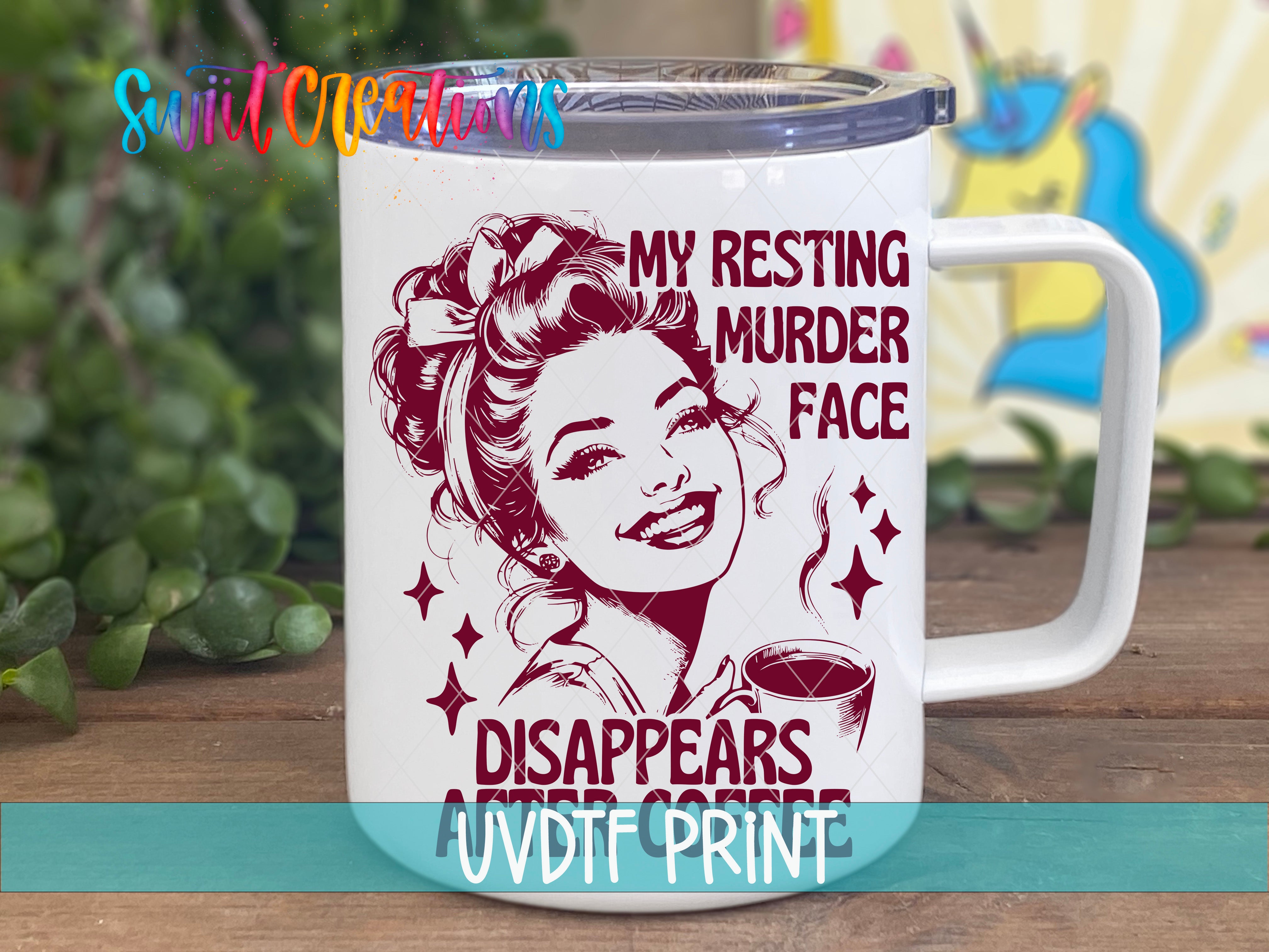 A white mug with a printed design featuring a smiling woman's face and text that reads "MY RESTING MURDER FACE DISAPPEARS AFTER COFFEE".