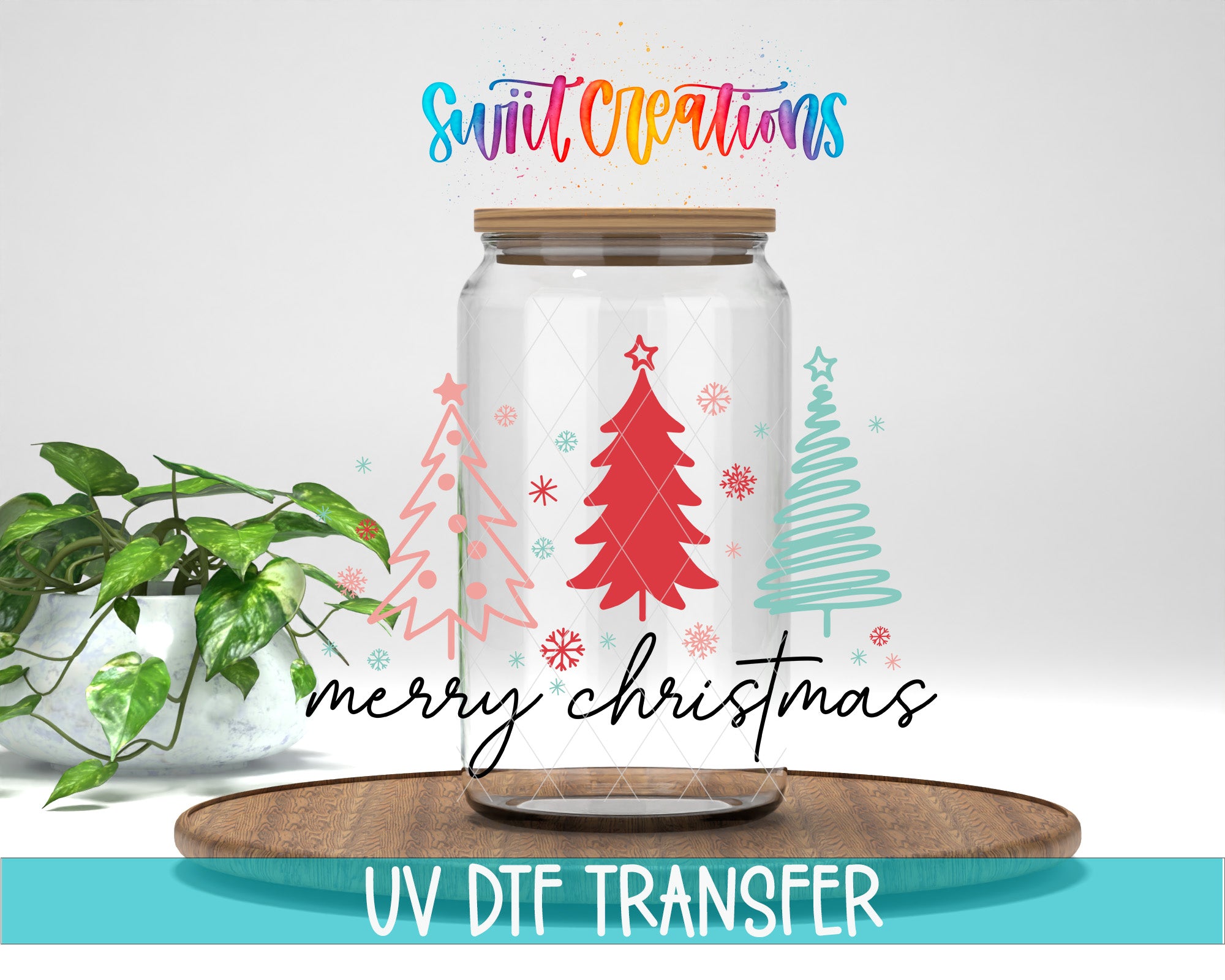 A glass jar with a Christmas tree design and snowflakes, placed on a wooden surface. The jar is surrounded by a potted plant and a wooden tray. The text "Merry Christmas" is displayed on the jar, and "UV DFT TRANSFER" is written at the bottom of the image.