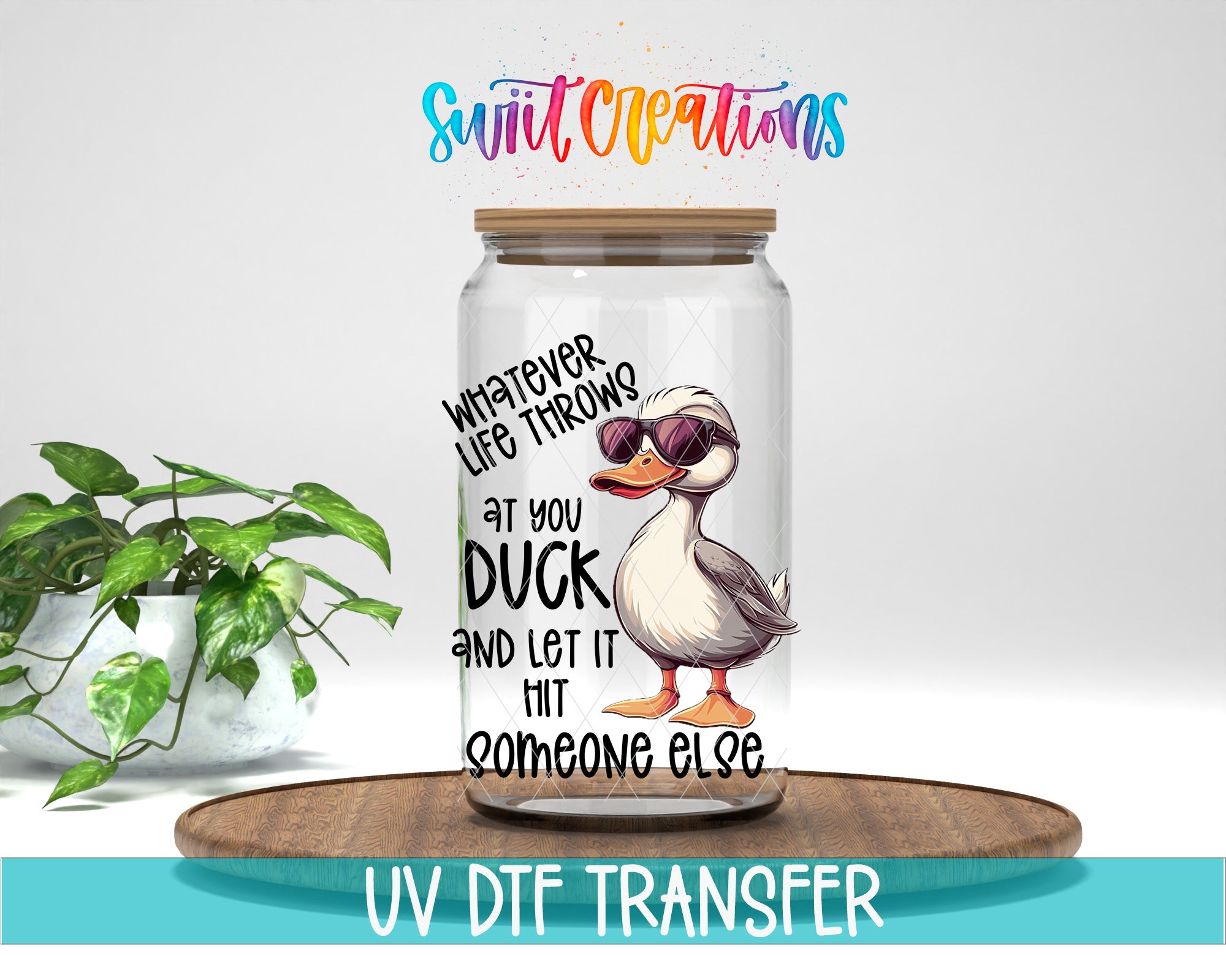 a glass jar with a cartoon duck wearing sunglasses, placed on a wooden surface. The jar has a label with text that reads "Whatever life throws at you, let it hit someone else".