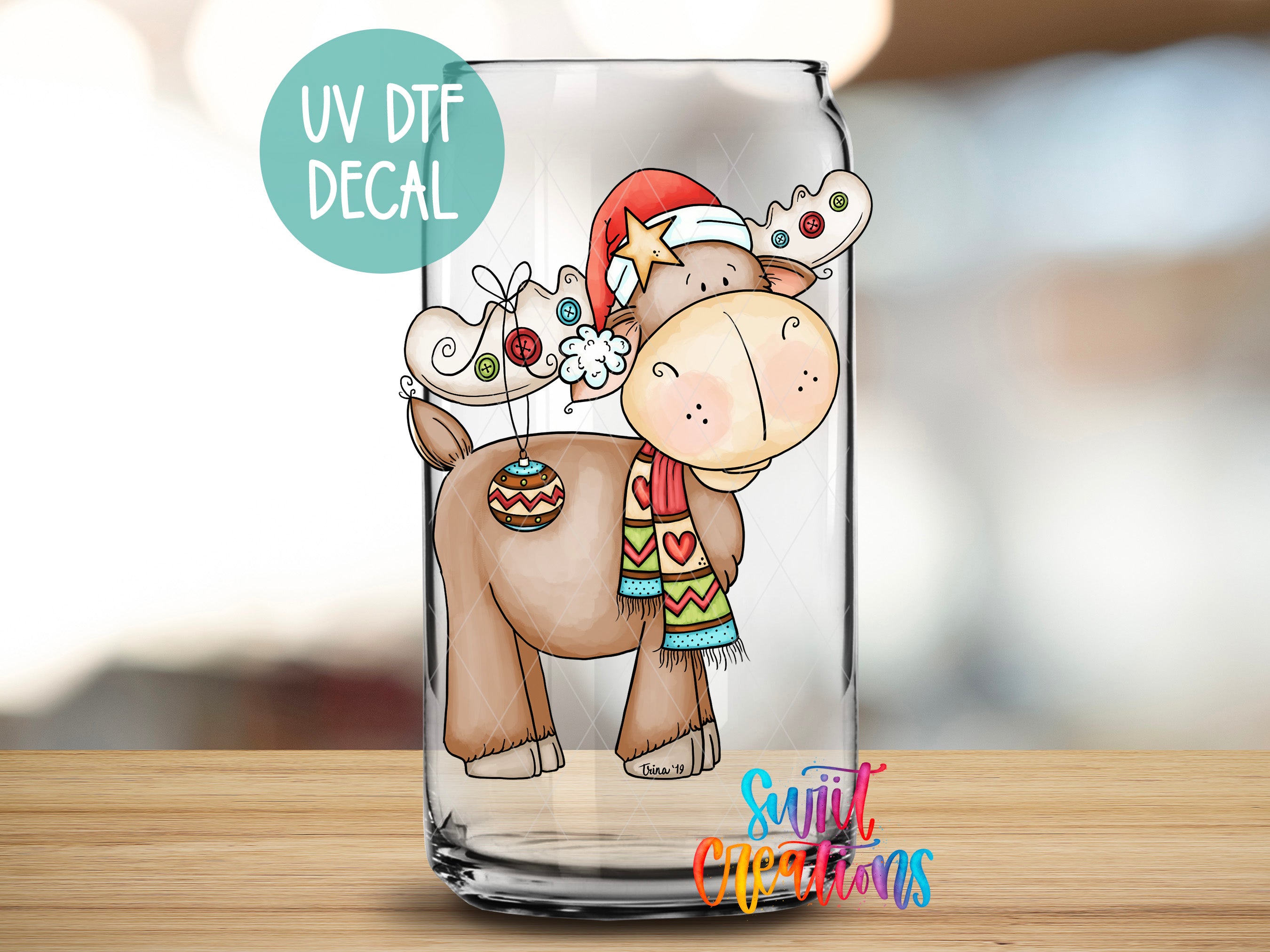 a glass with a picture of a moose wearing a santa hat
