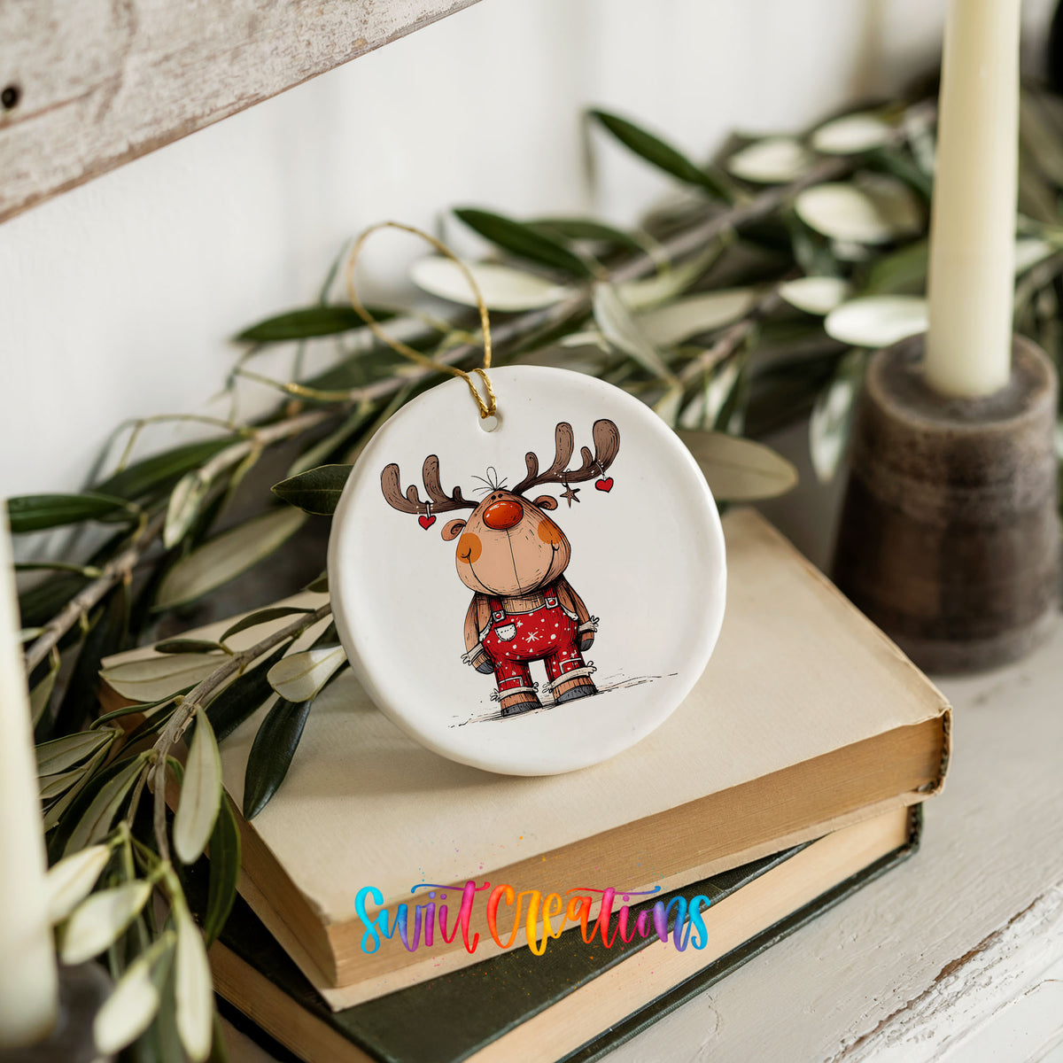 Reindeer in Red Plaid Sweater Christmas ornament styled on books with holiday greenery