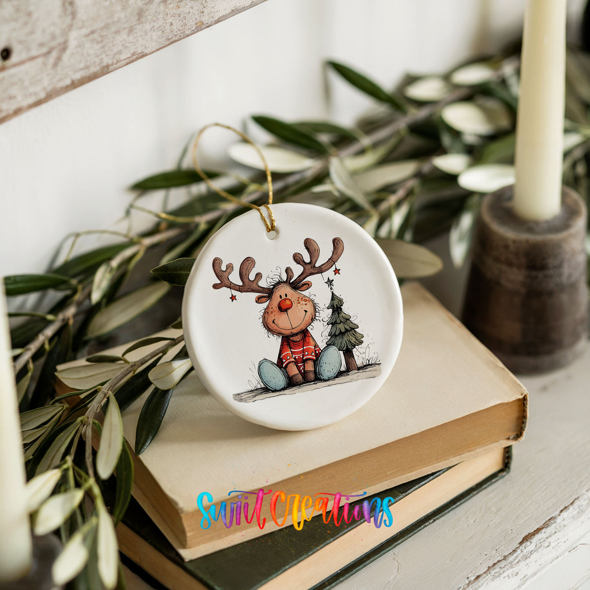 Sitting Reindeer with Gift and Christmas Tree Christmas ornament styled on books with holiday greenery