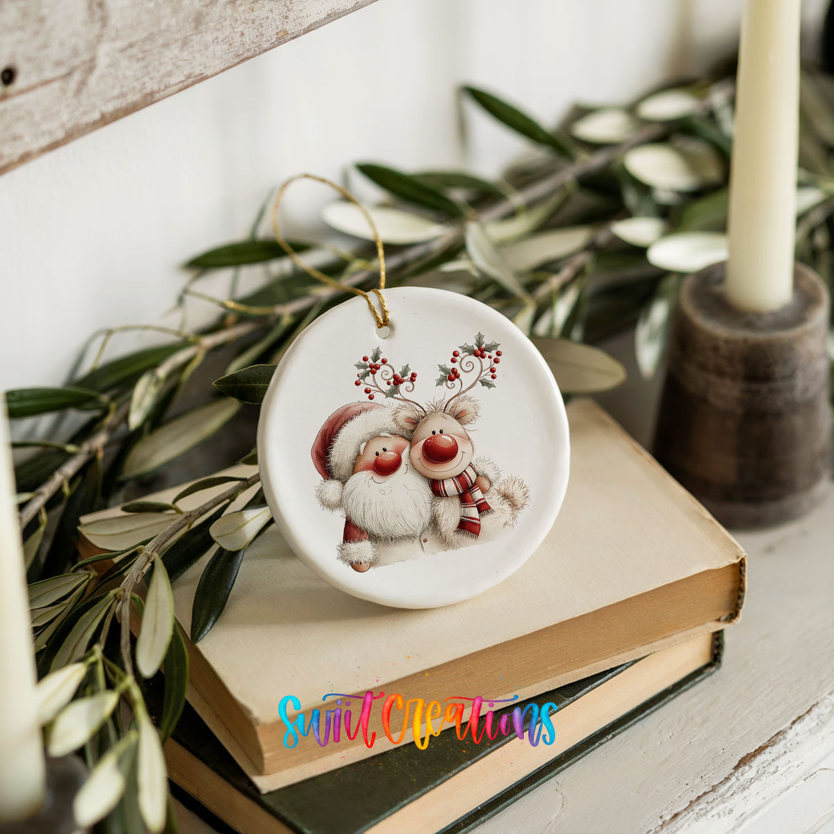 Santa Claus hugging a reindeer with holly antlers ceramic Christmas ornament styled on stacked books with greenery