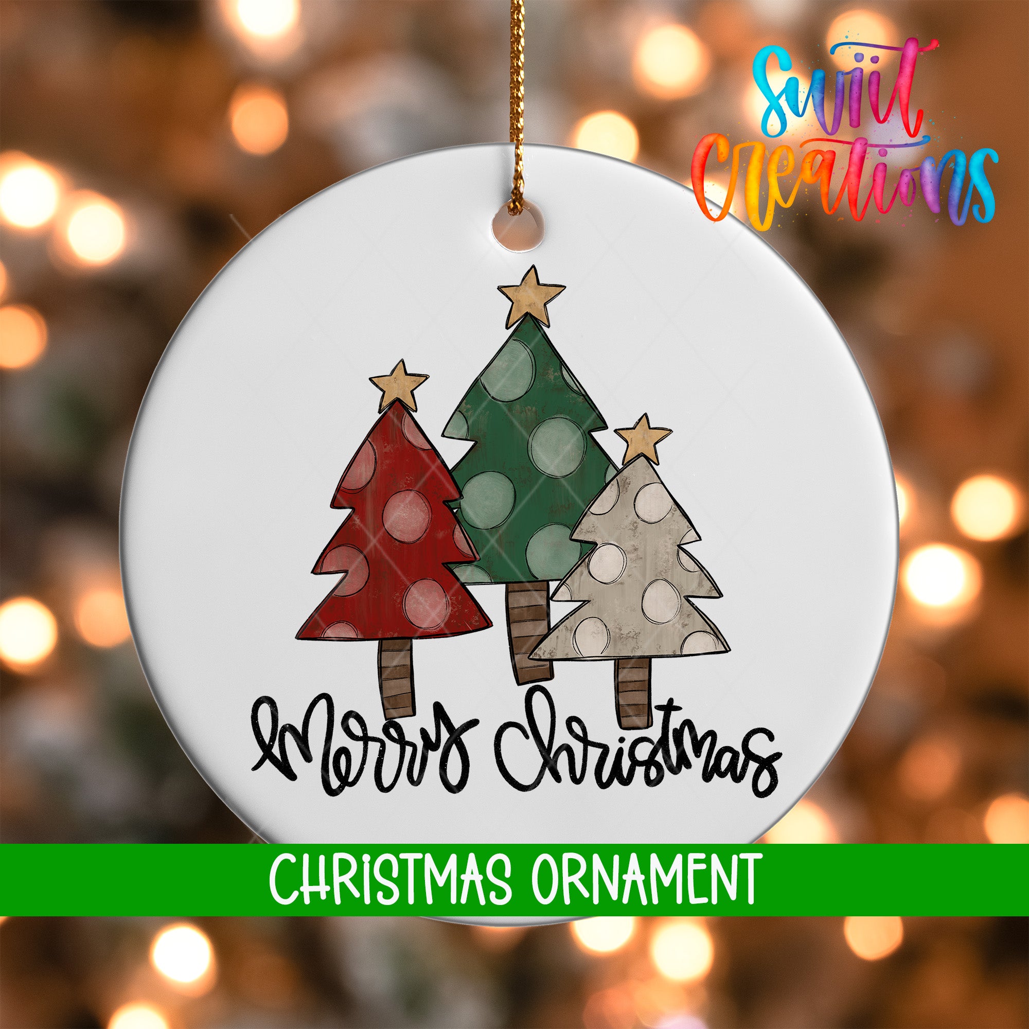 A white Christmas ornament with three trees, each with a different color and pattern, and the text "Merry Christmas" written below them.