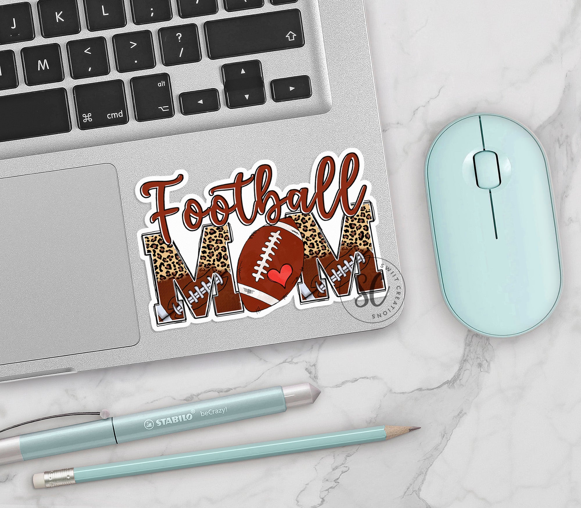 a laptop with a football mom sticker on it