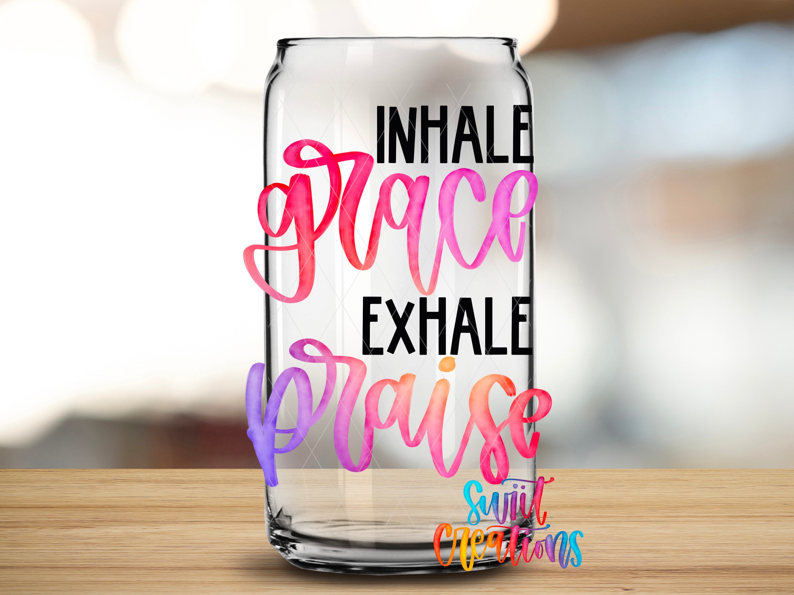 a clear glass can with colorful text and a watermark that says "Inhale, Place, Exhale, Praise" and "Suitcase Creations".