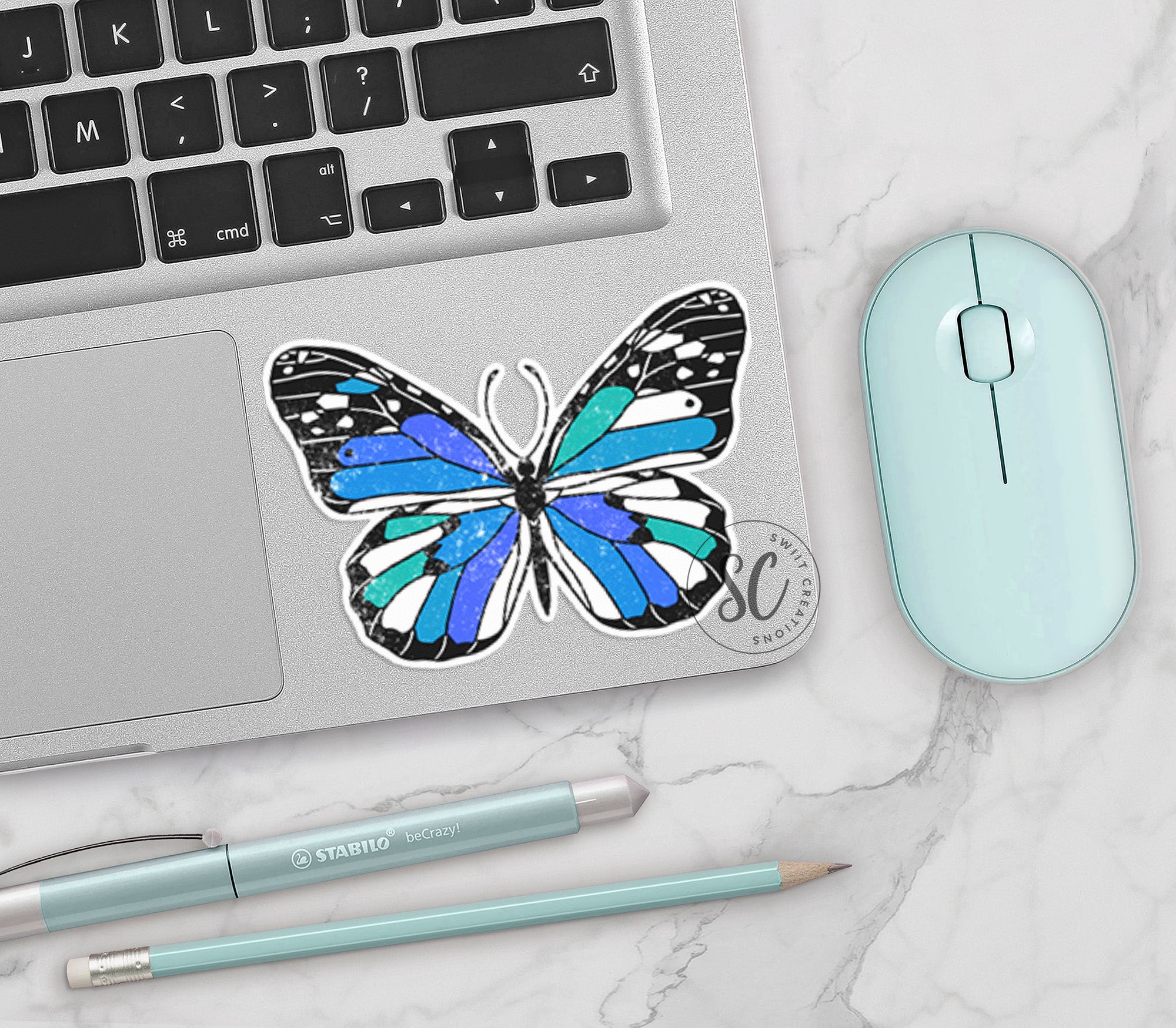 a laptop with a blue butterfly sticker on it